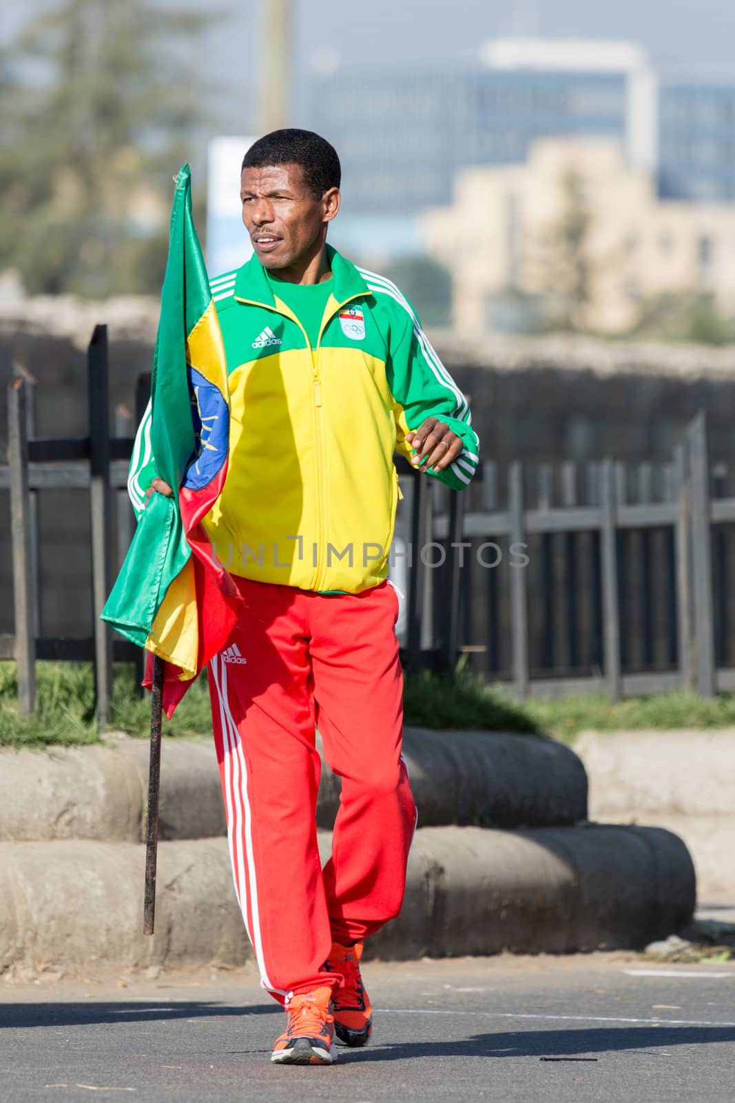 Addis Ababa, Ethiopia – November 24: World renowned athlete Haile Gebrselassie holding the Ethiopian flag at the 13th Edition Ethiopian Great Run, 24th of November 2013 in Addis Ababa, Ethiopia.