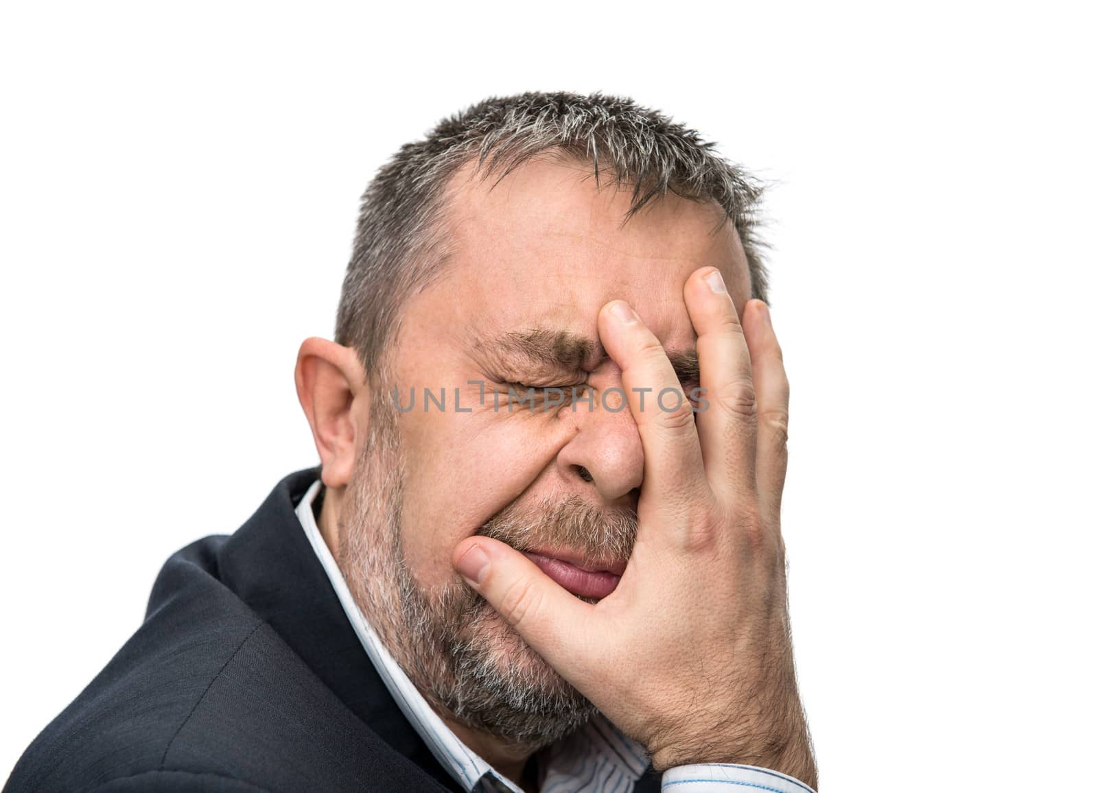 Headache. Portrait of an middle age man with face closed by hand. Isolated on white
