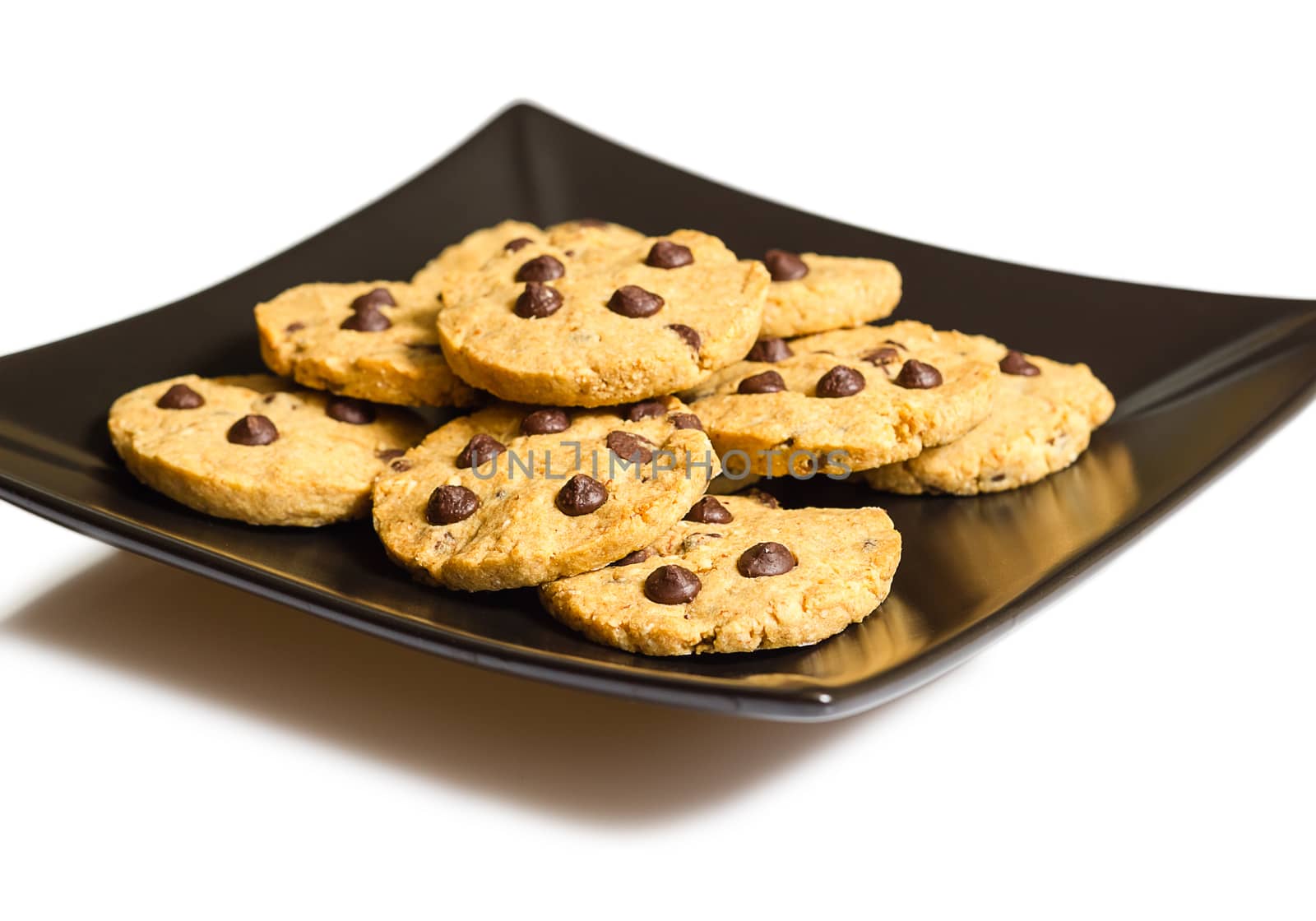 Chocolate chip cookies on a black plate isolated on white backgr by doble.d