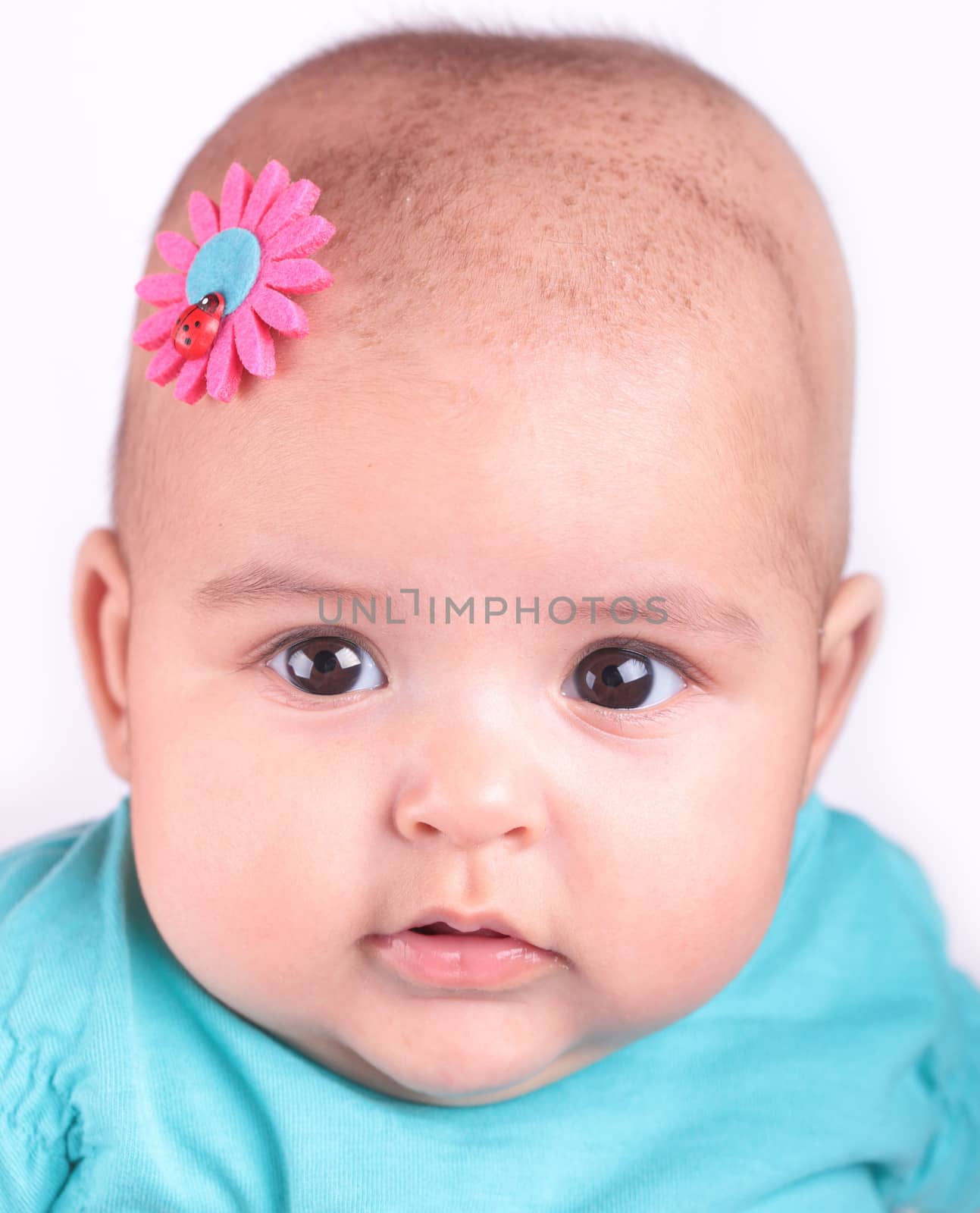 portrait of a beautiful baby with a flower on her head