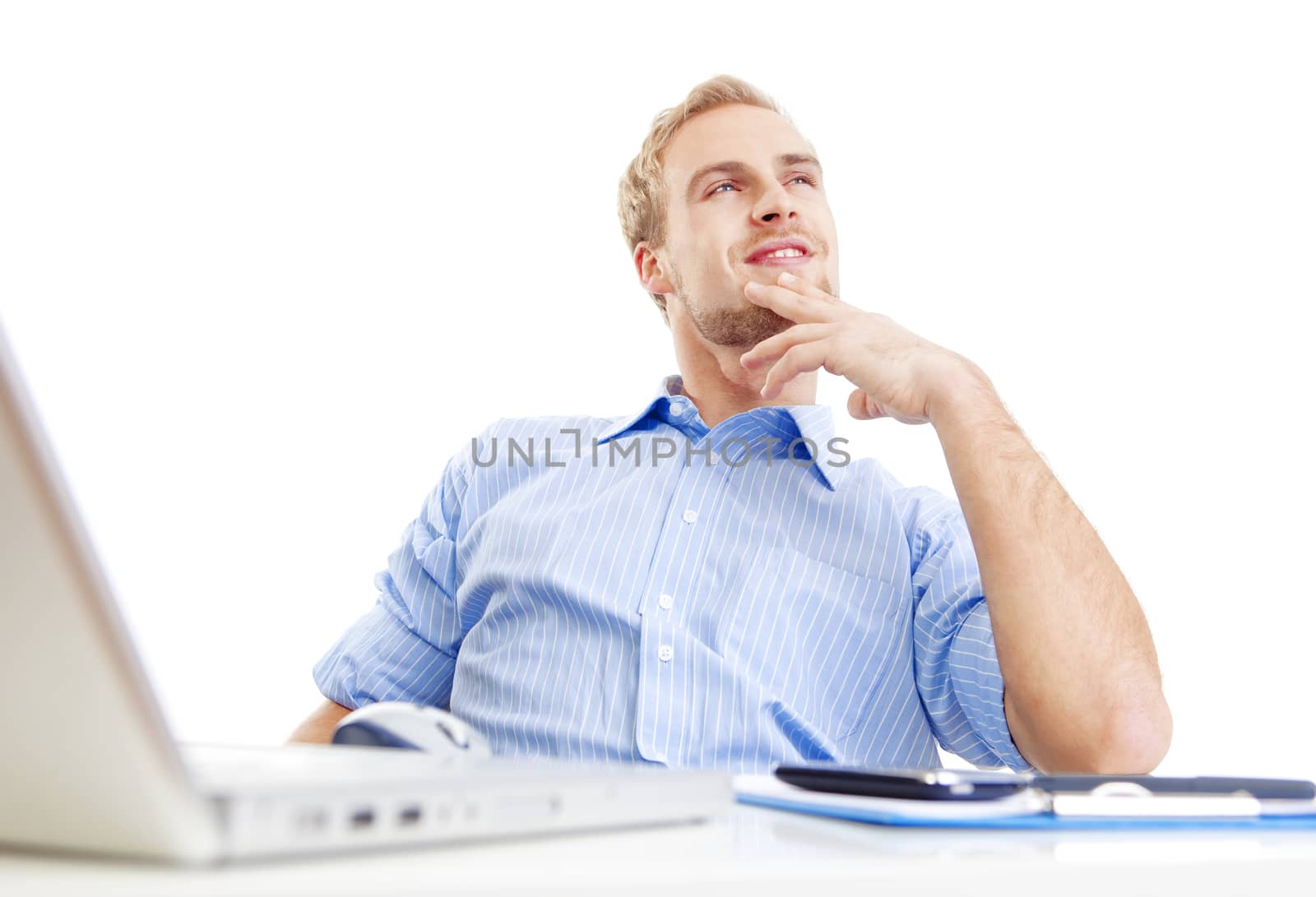 young man at office, sitting leaning back daydreaming, smiling