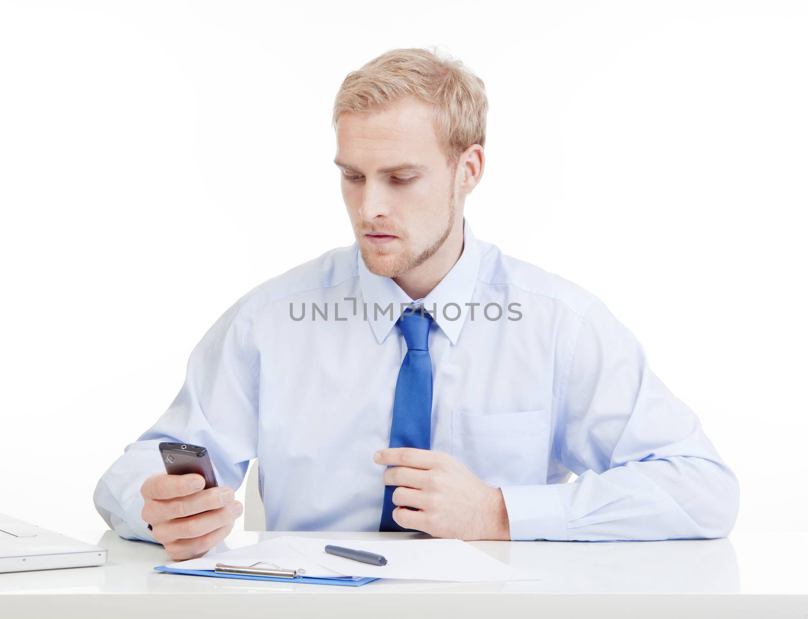 young man at office with mobile phone by courtyardpix