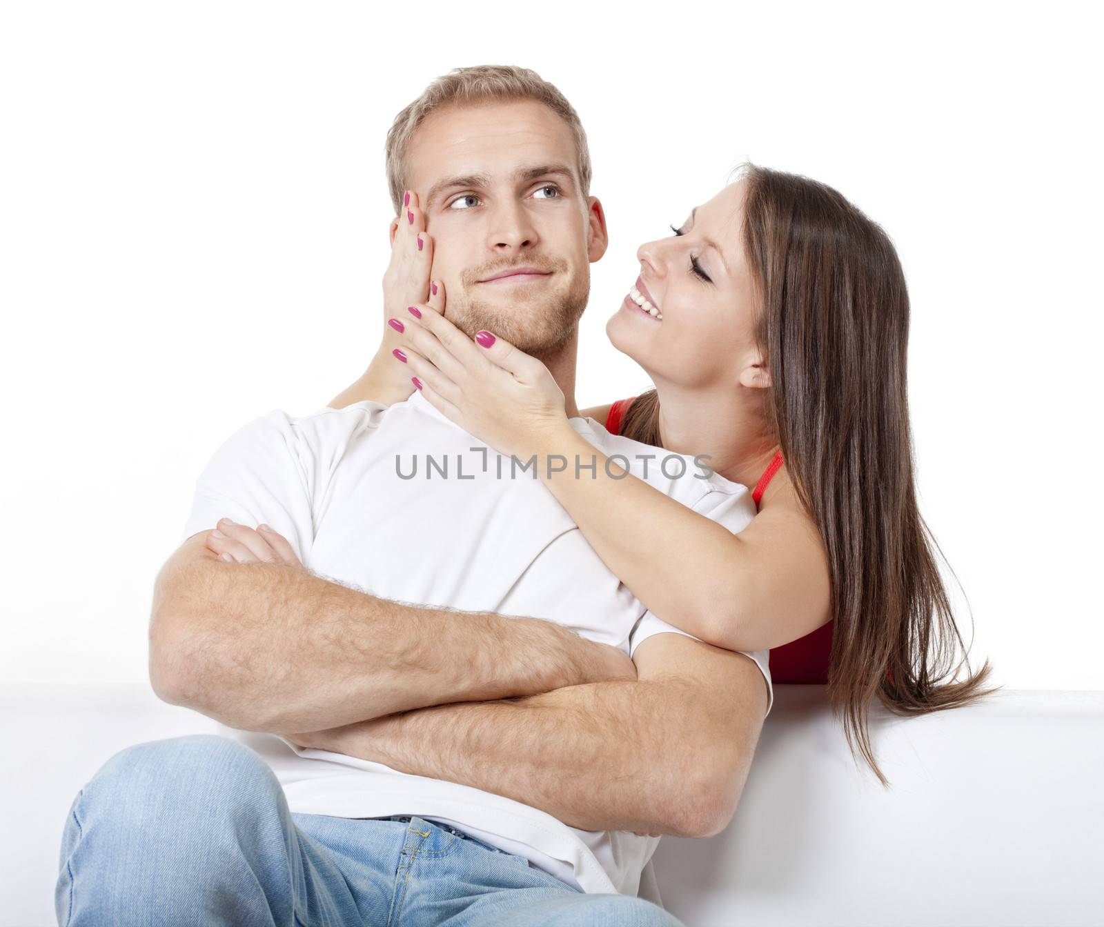 young couple home - woman trying to please her serious boyfriend