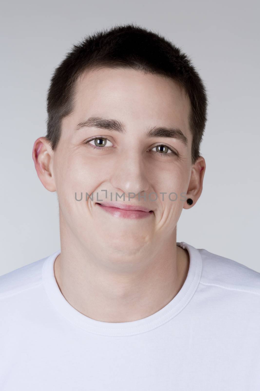 portrait of a young man with dark hair smiling