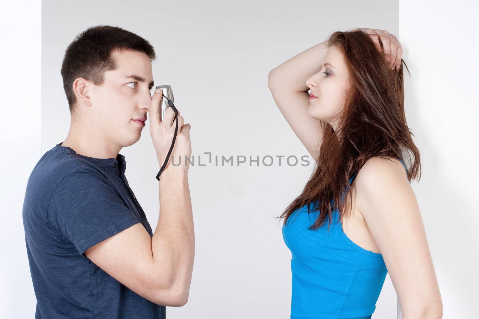 young man taking pictures of his girlfriend