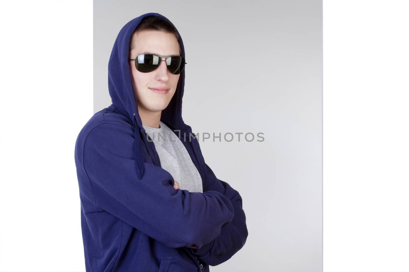 portrait of a young man with sunglasses and hood