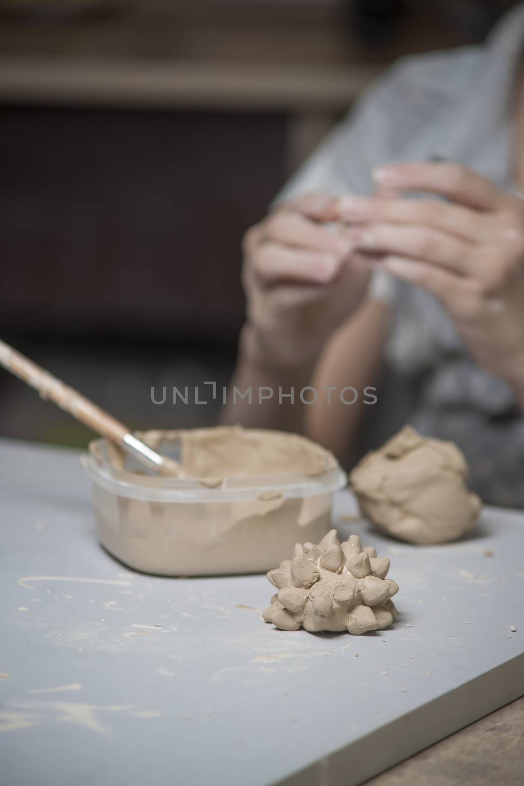 Girl make toyfrom clay. High resolution image.