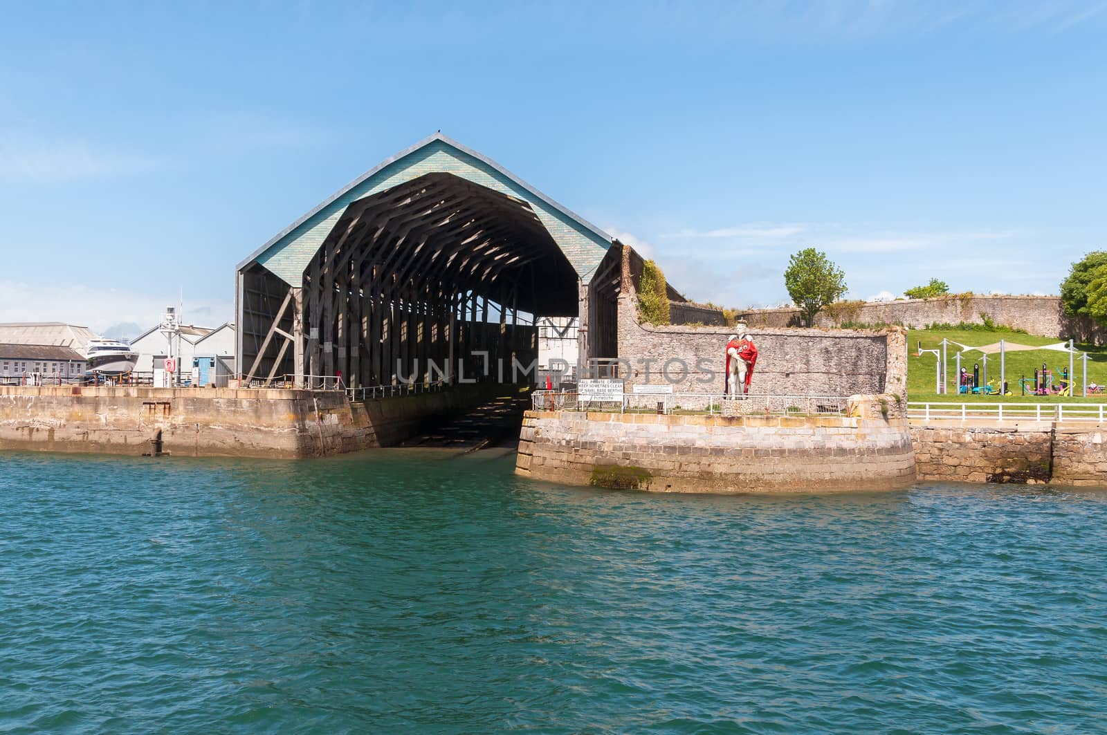 Harbor hangar with statue in Plymouth, Great Britain