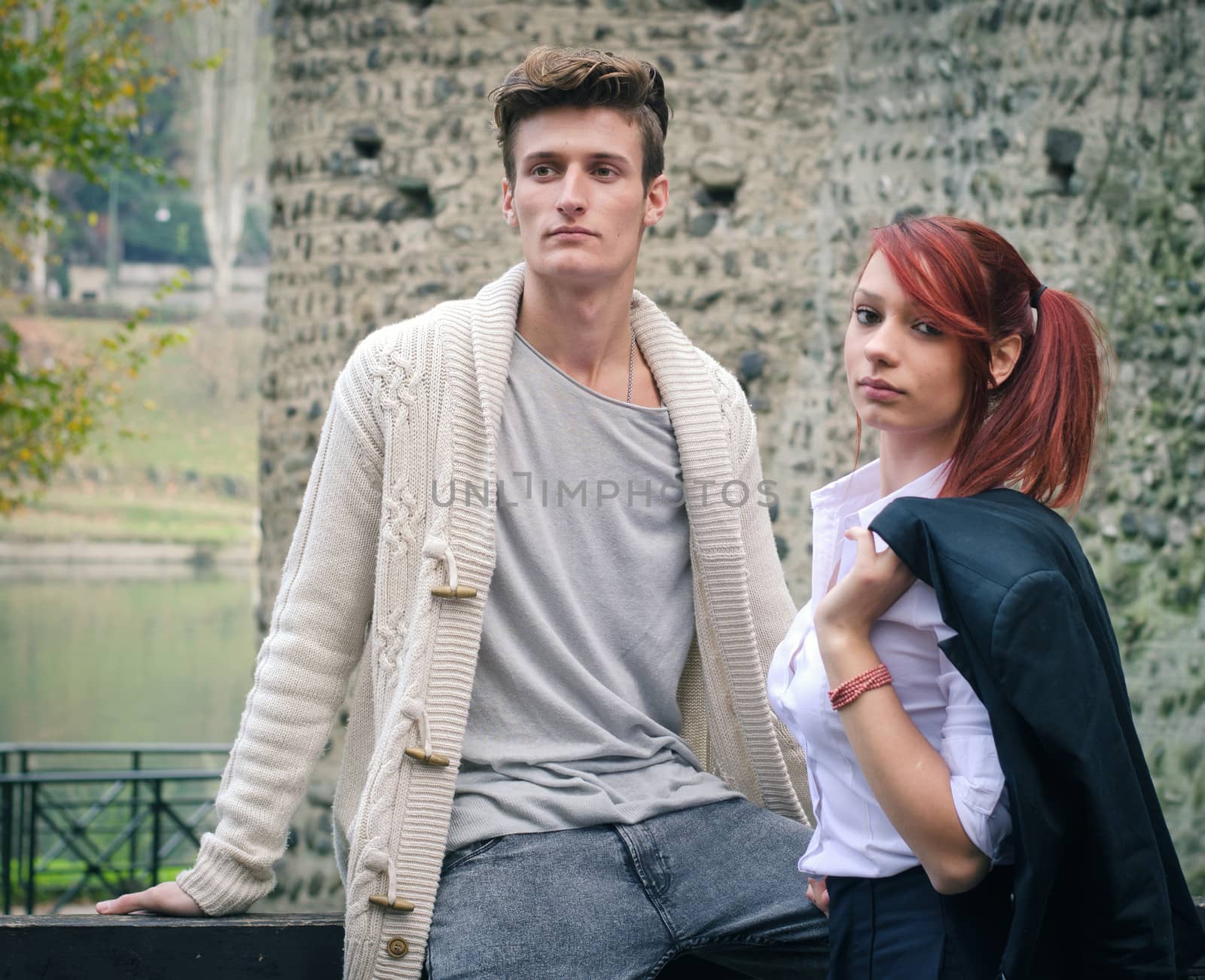 Young elegant couple outdoors near old stone wall by artofphoto