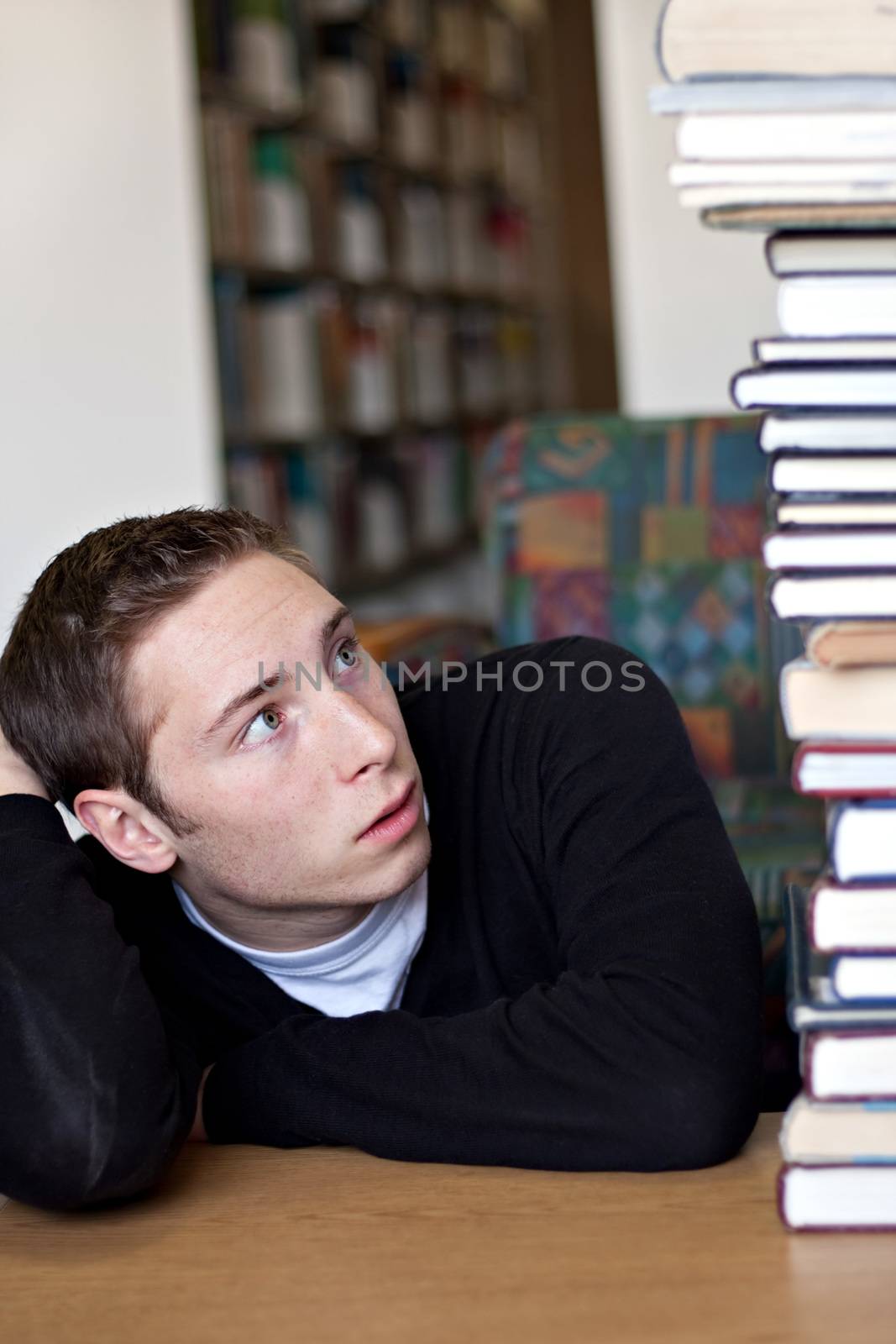 Student Looking Up At Pile of Books by graficallyminded