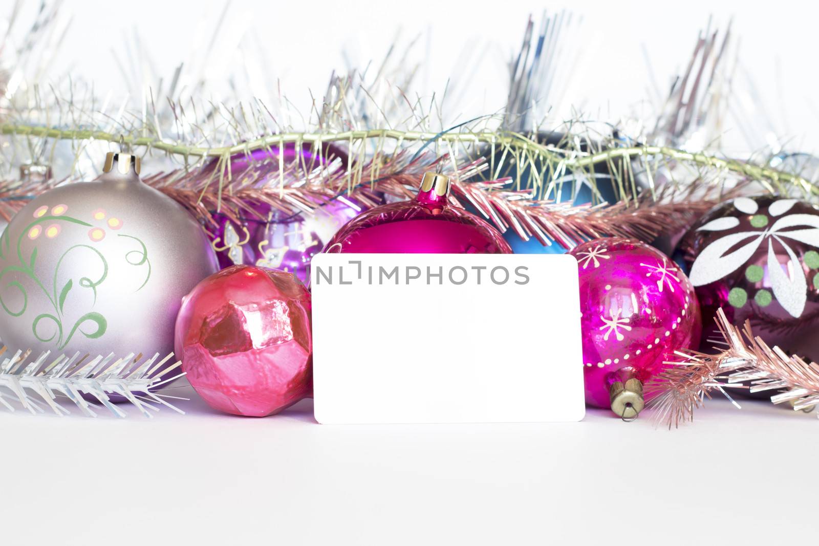 Arrangement of Christmas tree decorations and white card. white background