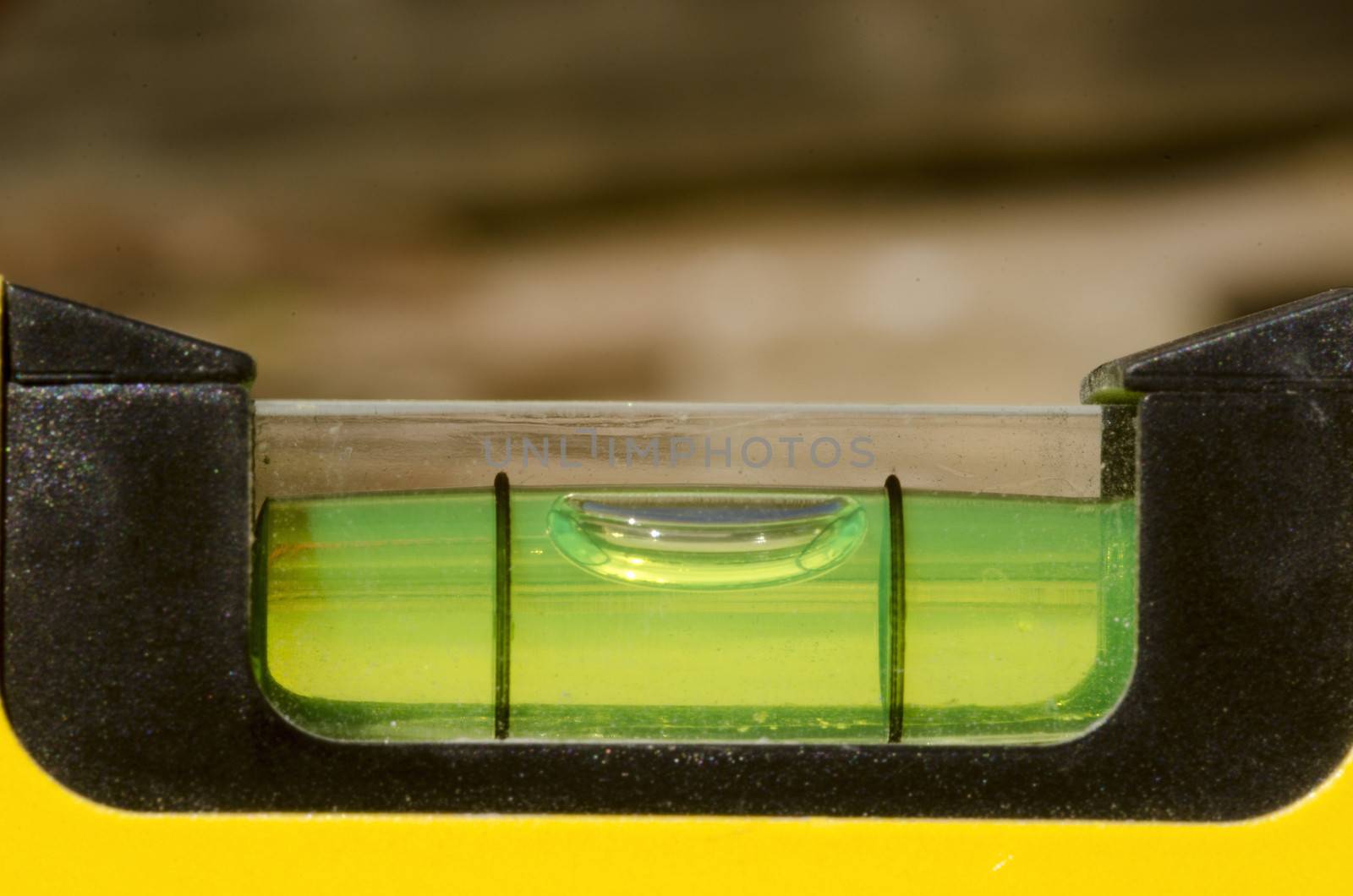 Detail of spirit level with glass cover and yellow base