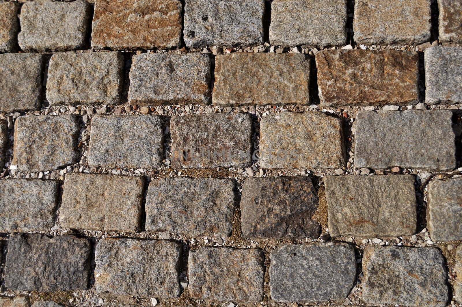 Fragment of old gray stone pavement surface