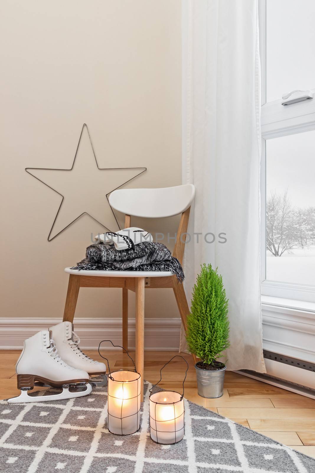 Cozy winter composition in a room, with snowy landscape seen through the window.