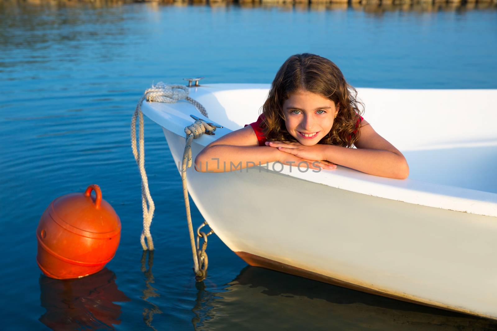 Sailor kid girl happy smiling relaxed in boat bow by lunamarina