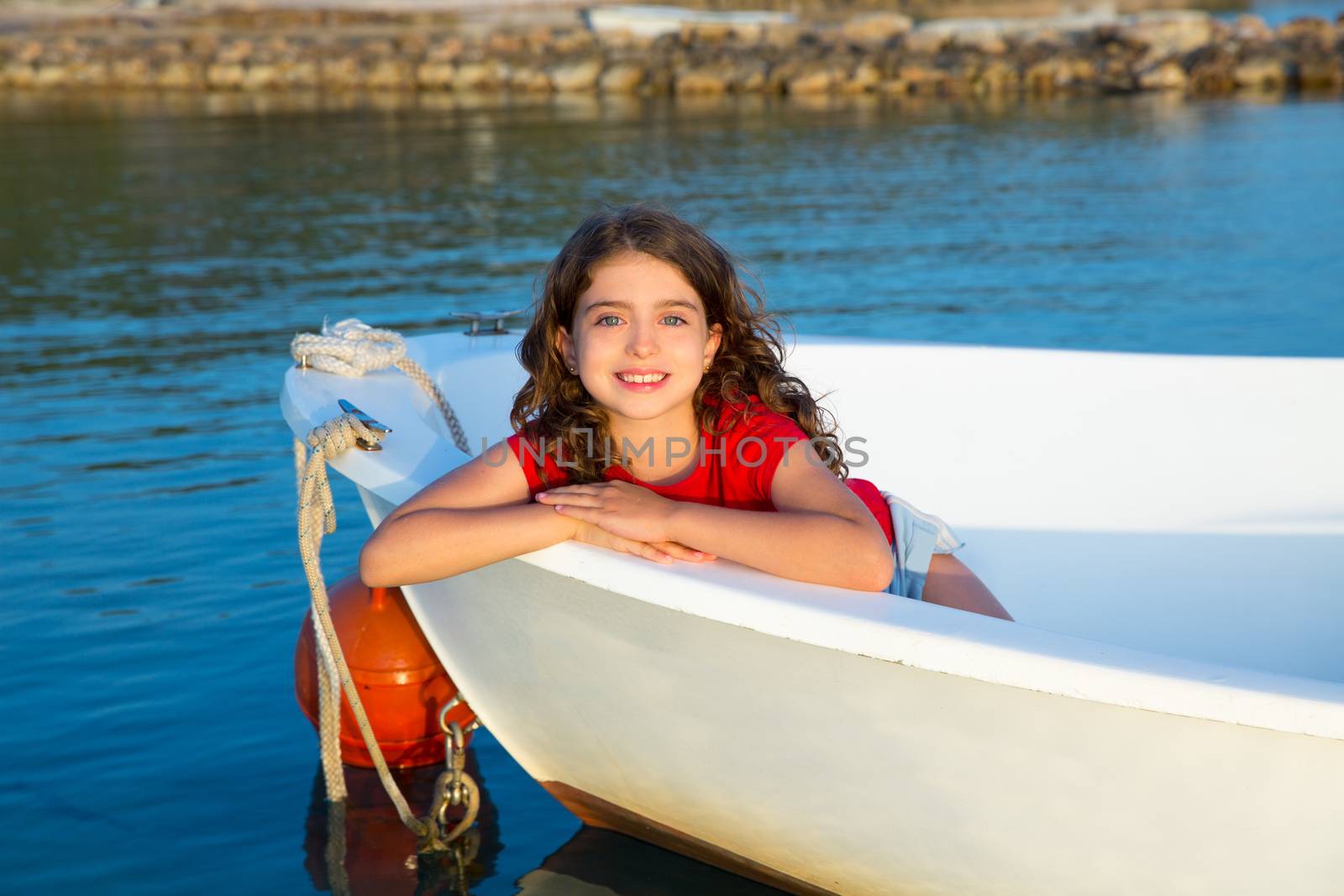 Sailor kid girl happy smiling relaxed in boat bow at Formentera Balearic Islands