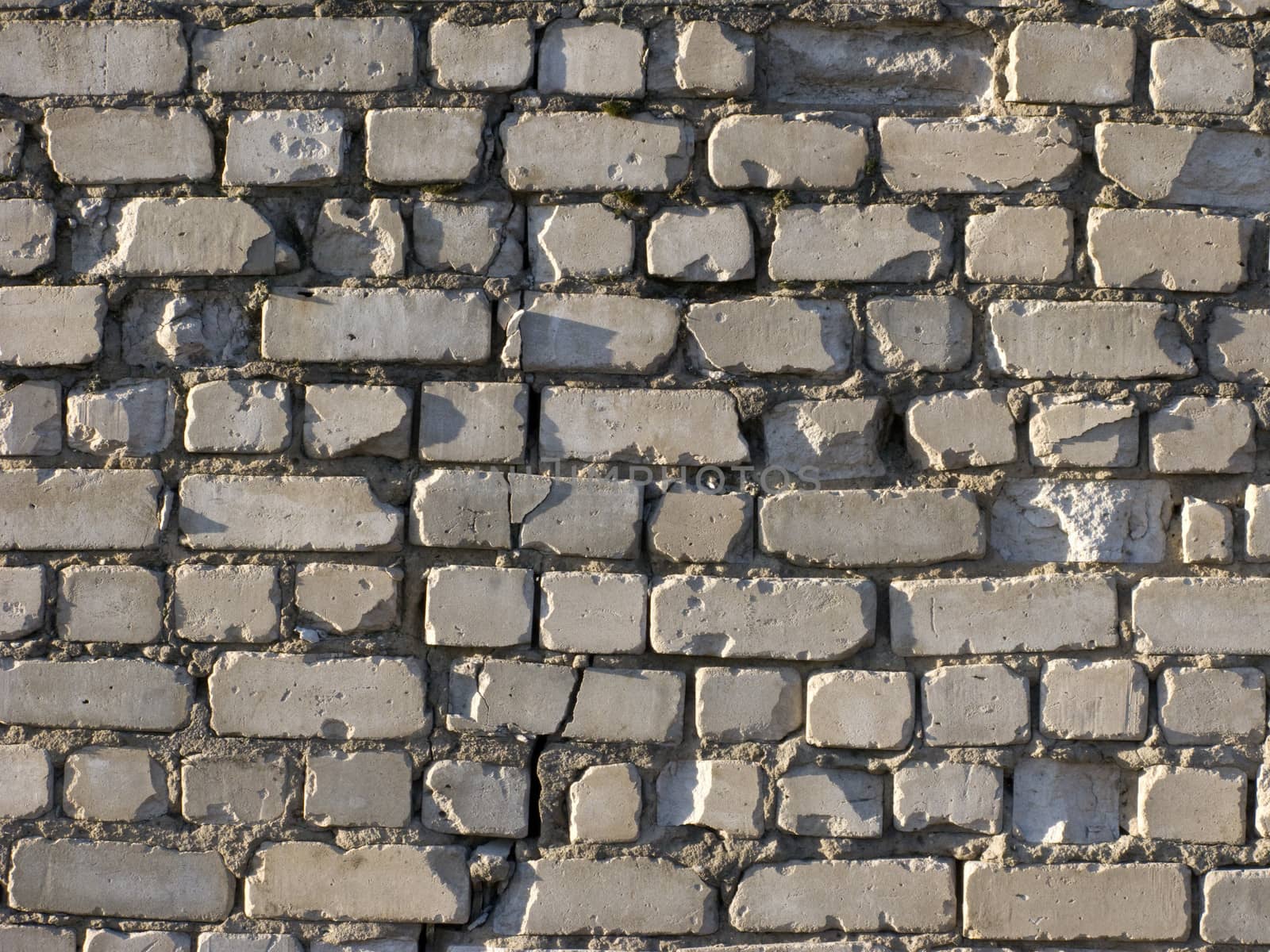 Fragment of old grey brick wall surface