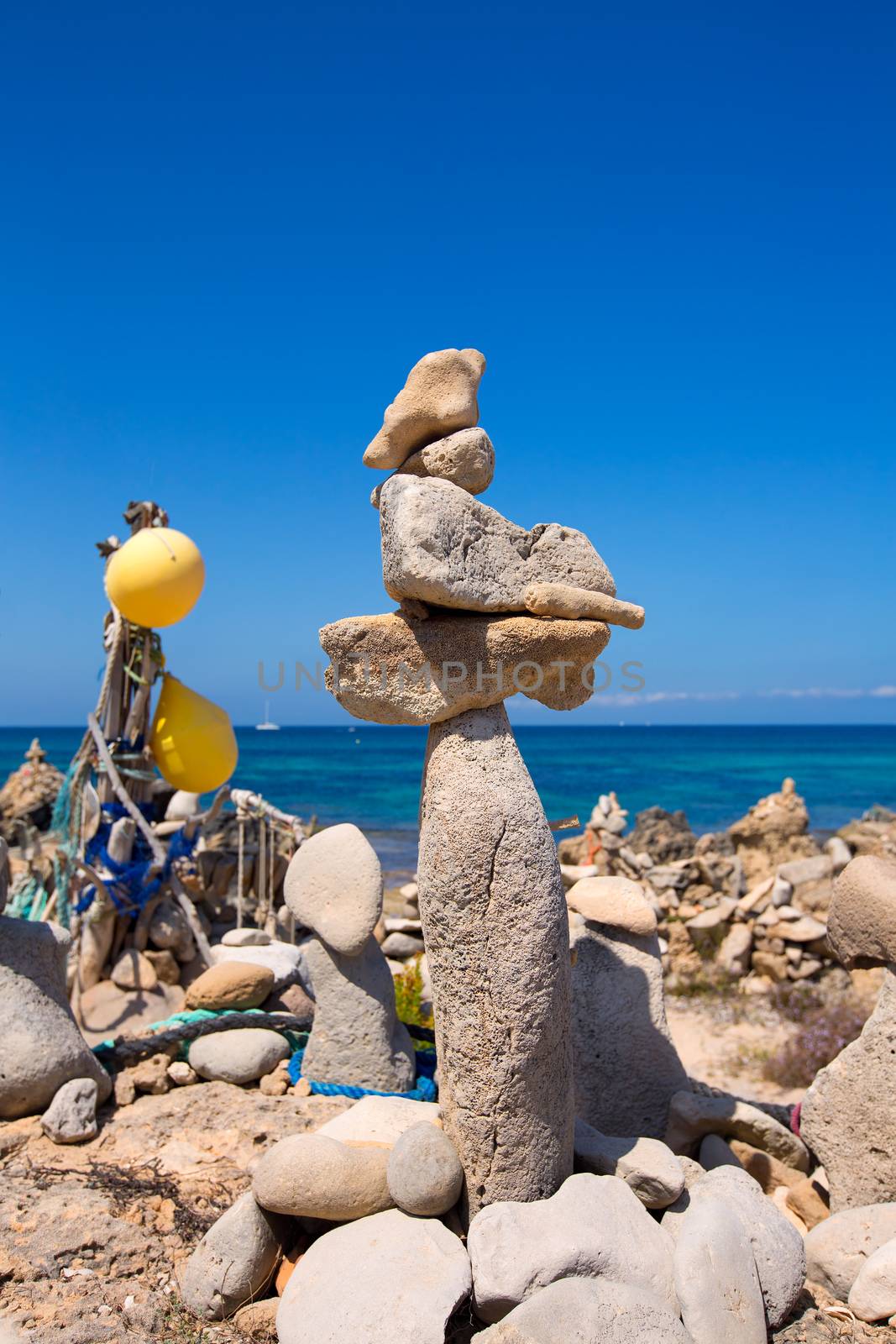 Stone figures on beach shore of Illetes beach in Formentera Mediterranean Balearic Islands