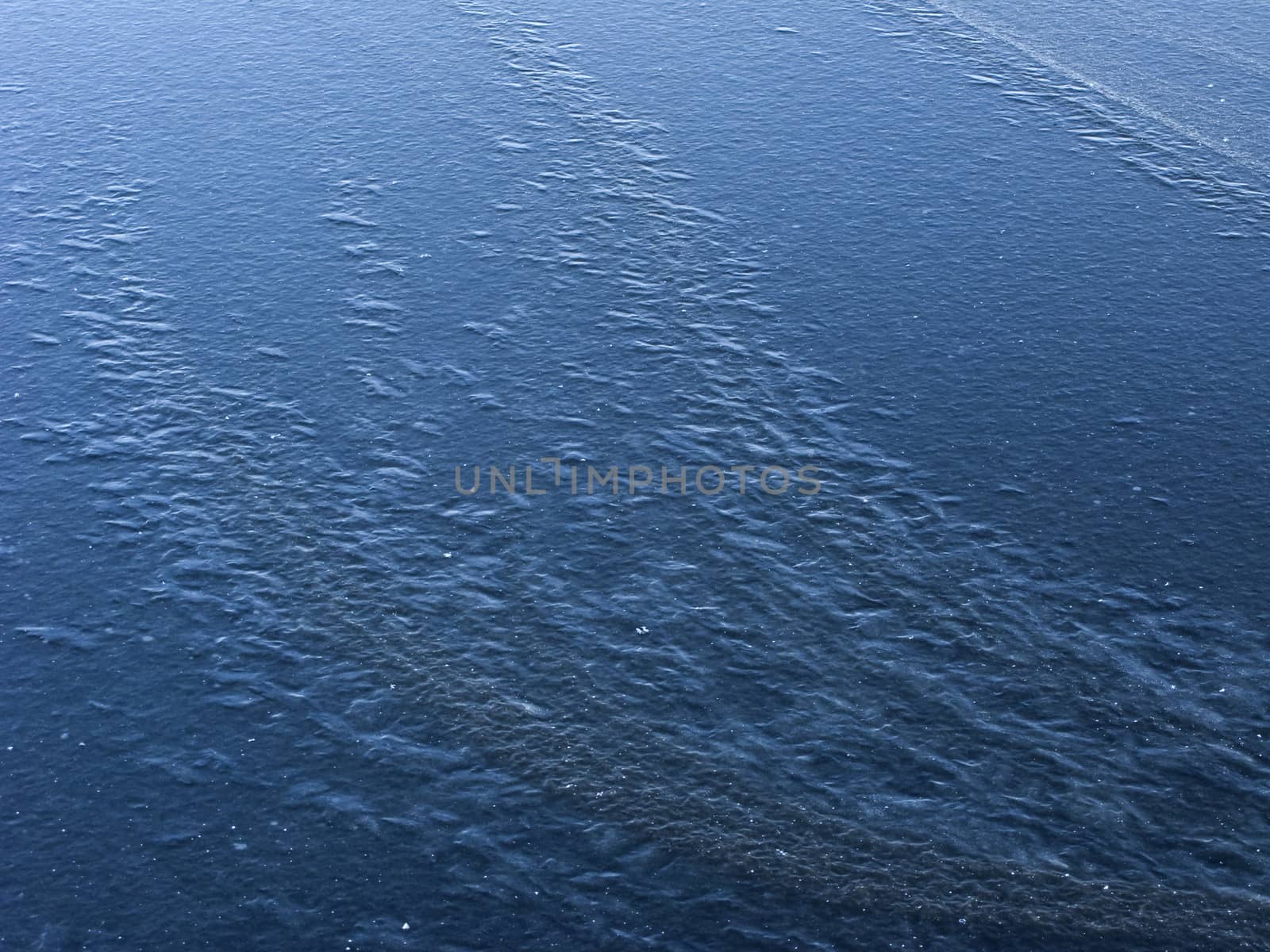 New blue ice surface background on frozen pond