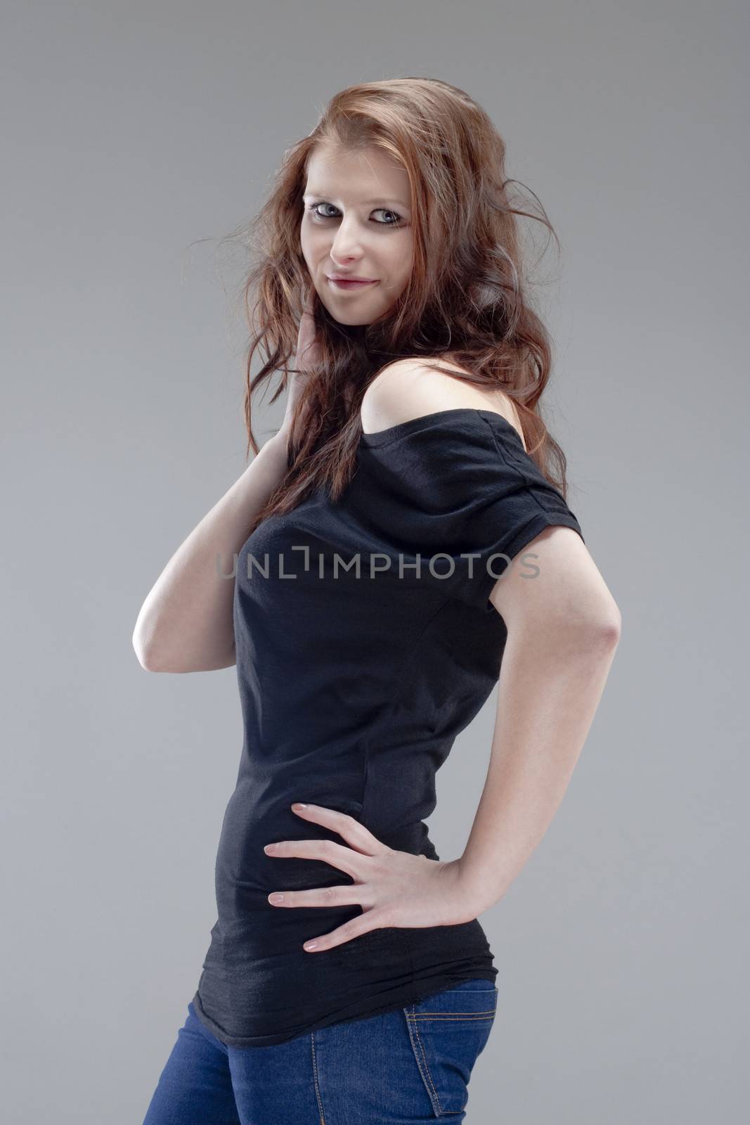 portrait of a young beautiful woman with brown hair - isolated on gray