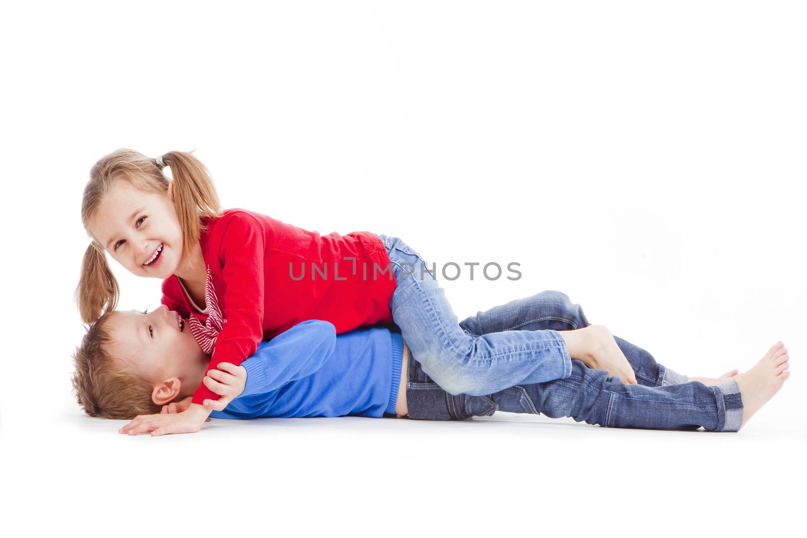 brother and sister having fun with each other - isolated on white