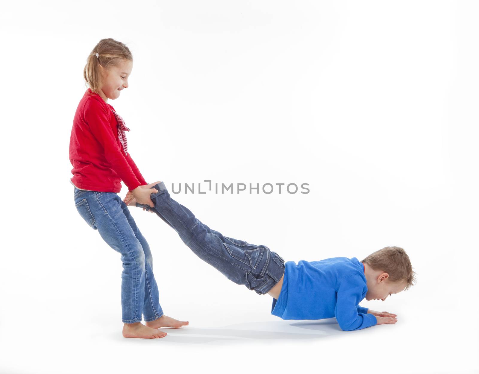 brother and sister having fun with each other - isolated on white