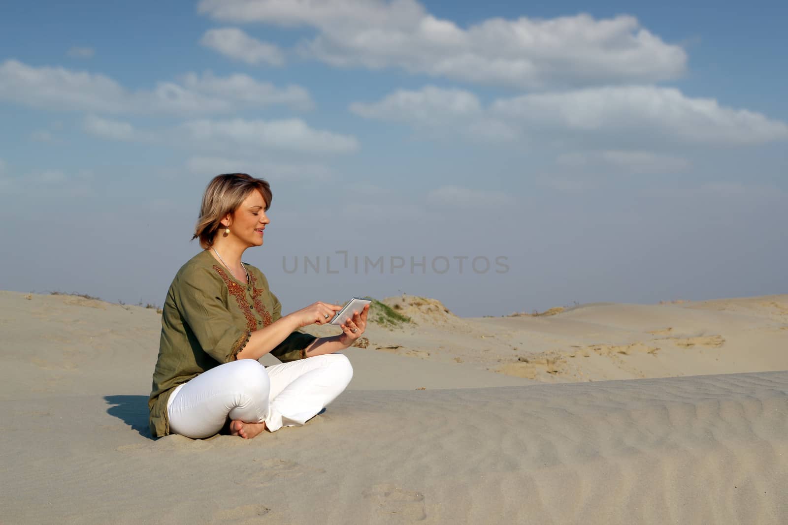 beautiful woman with tablet pc in the desert