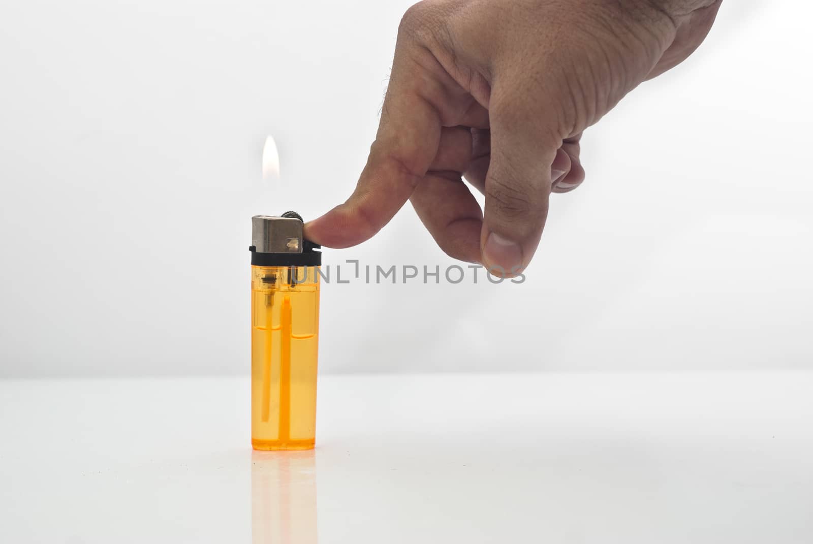 male hand holding a orange lighters isolated on white background