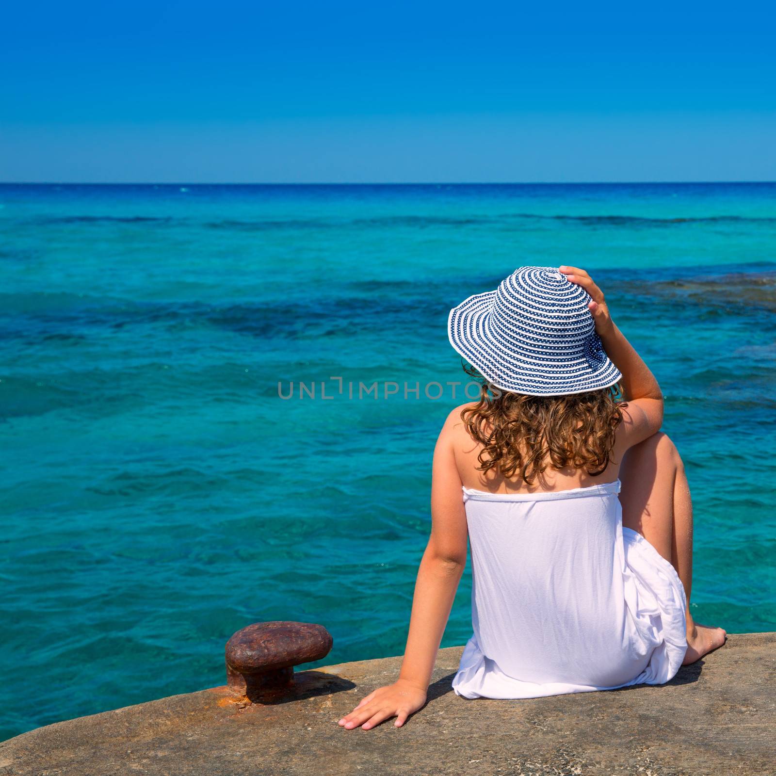 Girl looking at beach in Formentera turquoise Mediterranean sea background