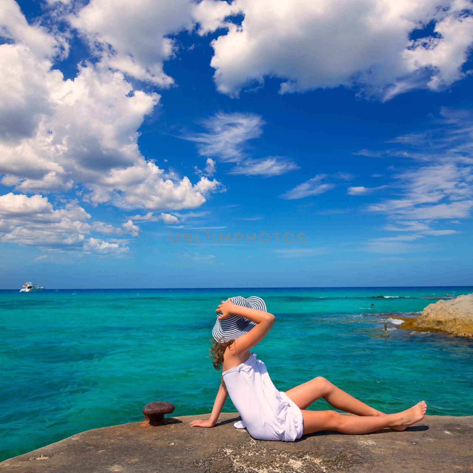 Girl looking at beach in Formentera turquoise Mediterranean by lunamarina