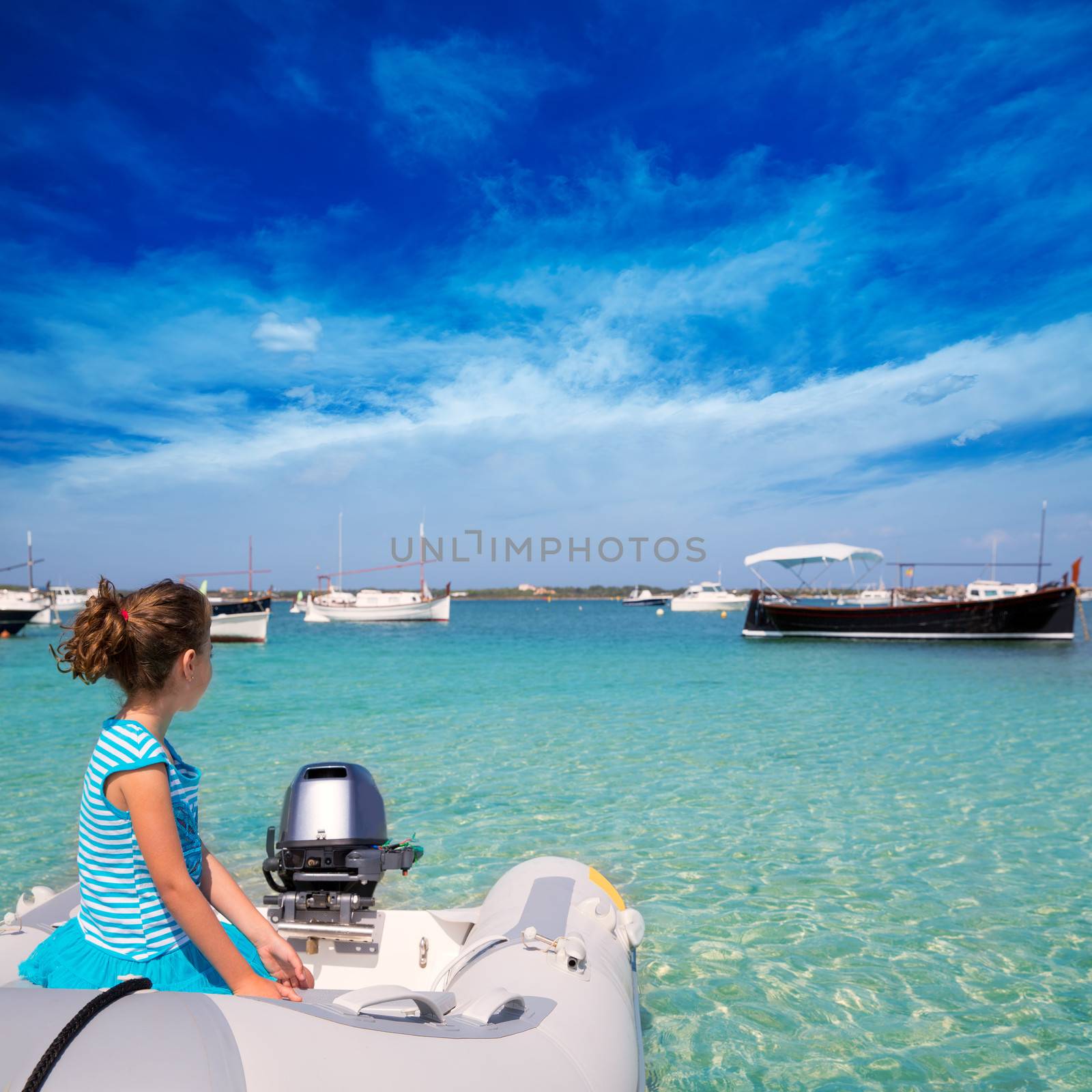 Kid girl in boat at formentera Estany des Peix by lunamarina