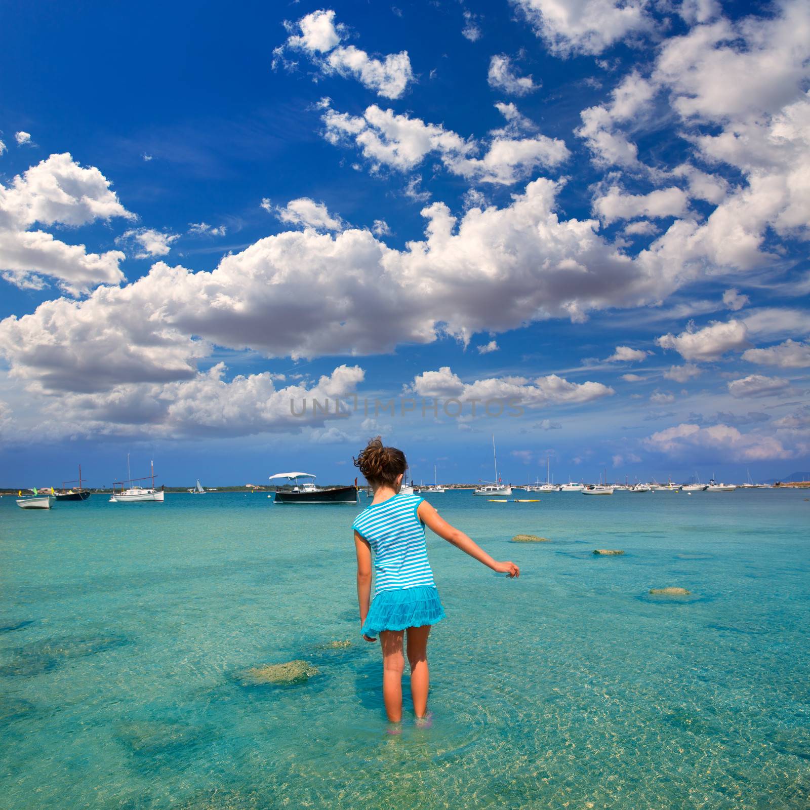 Kid girl walking at Formetera in Estany des Peix by lunamarina