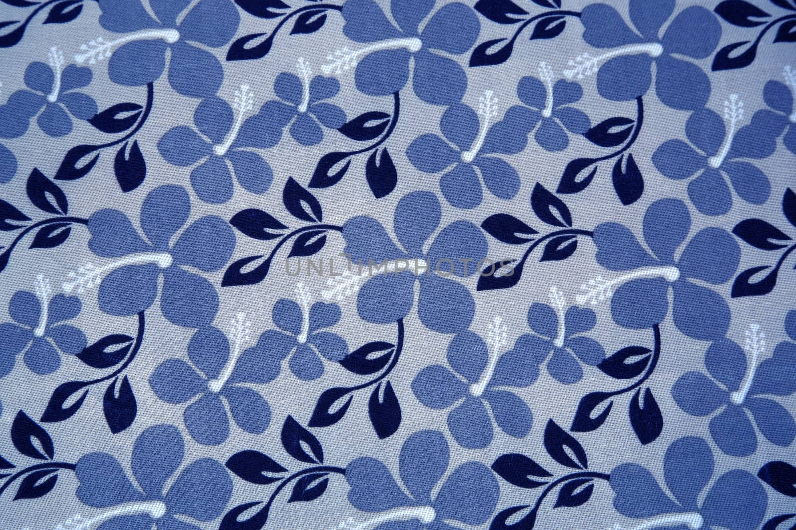 Blue flowers and navy blue leaves on a textil background