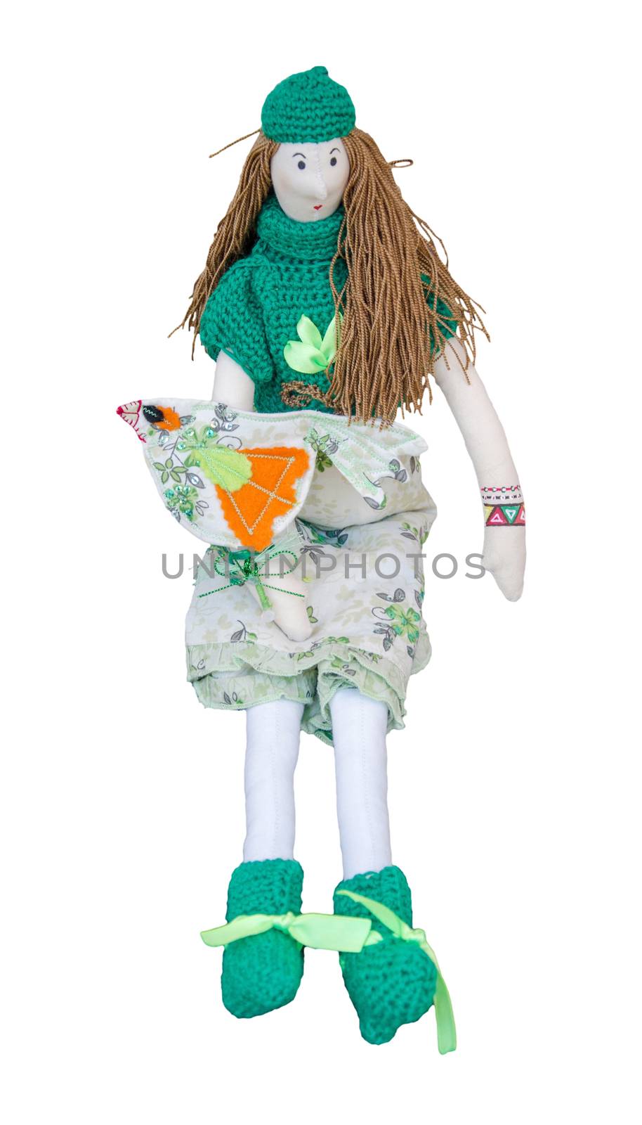 The Handmade doll with a bird on the hand in a dress and sweatersitting isolated