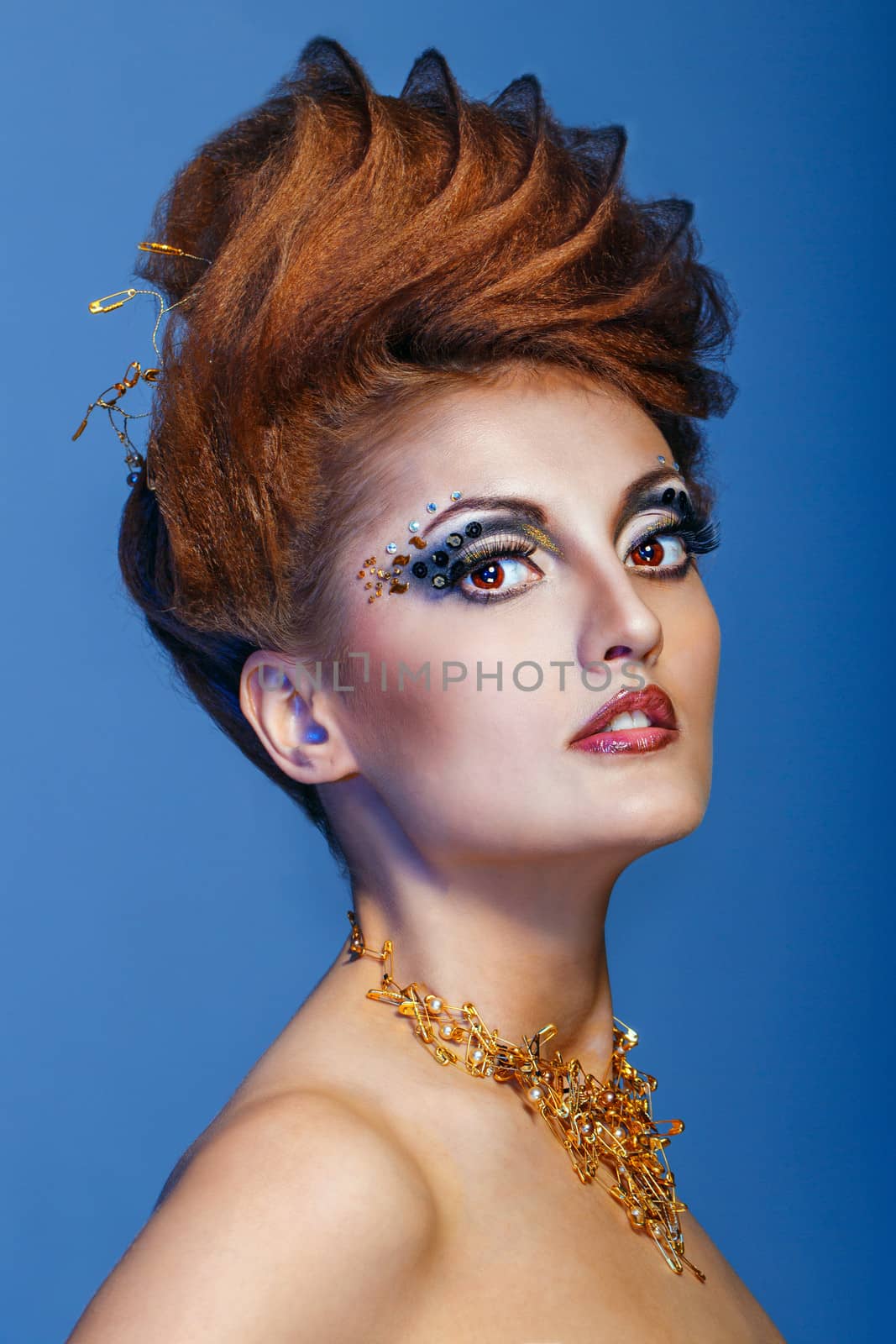 Close-up portrait of a young and attractive girl with hairstyle and jewelry