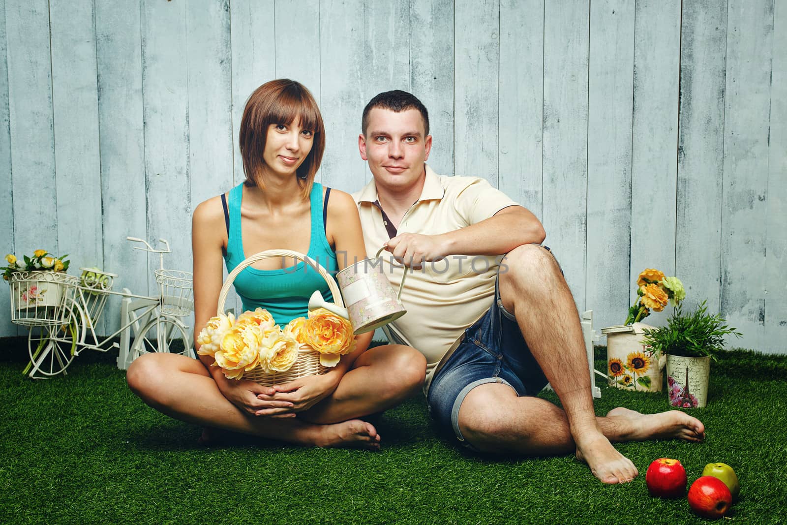 Young, happy married couple relaxing on the lawn and enjoys