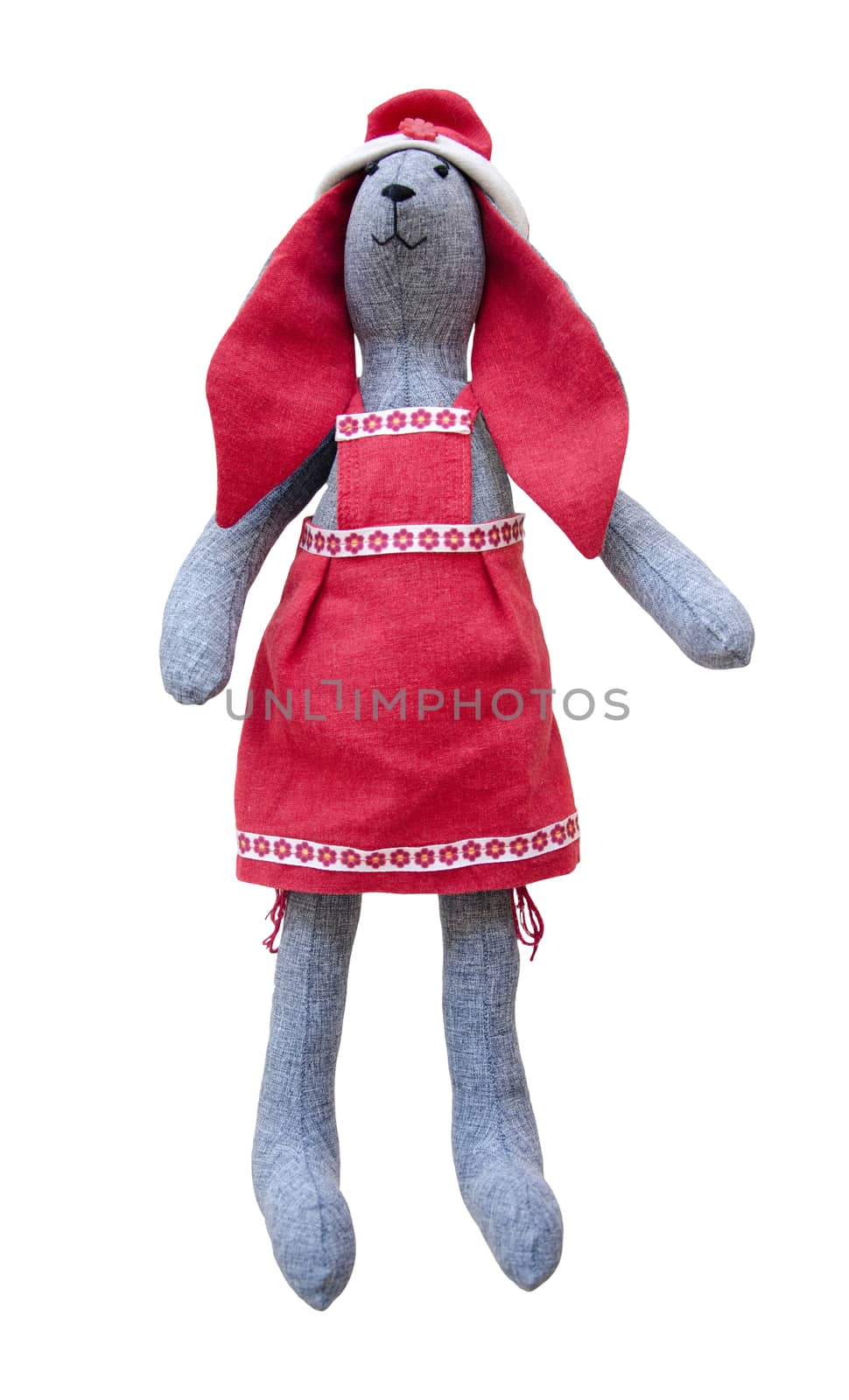 Isolated handmade doll hare with red ears in red apron by pt-home