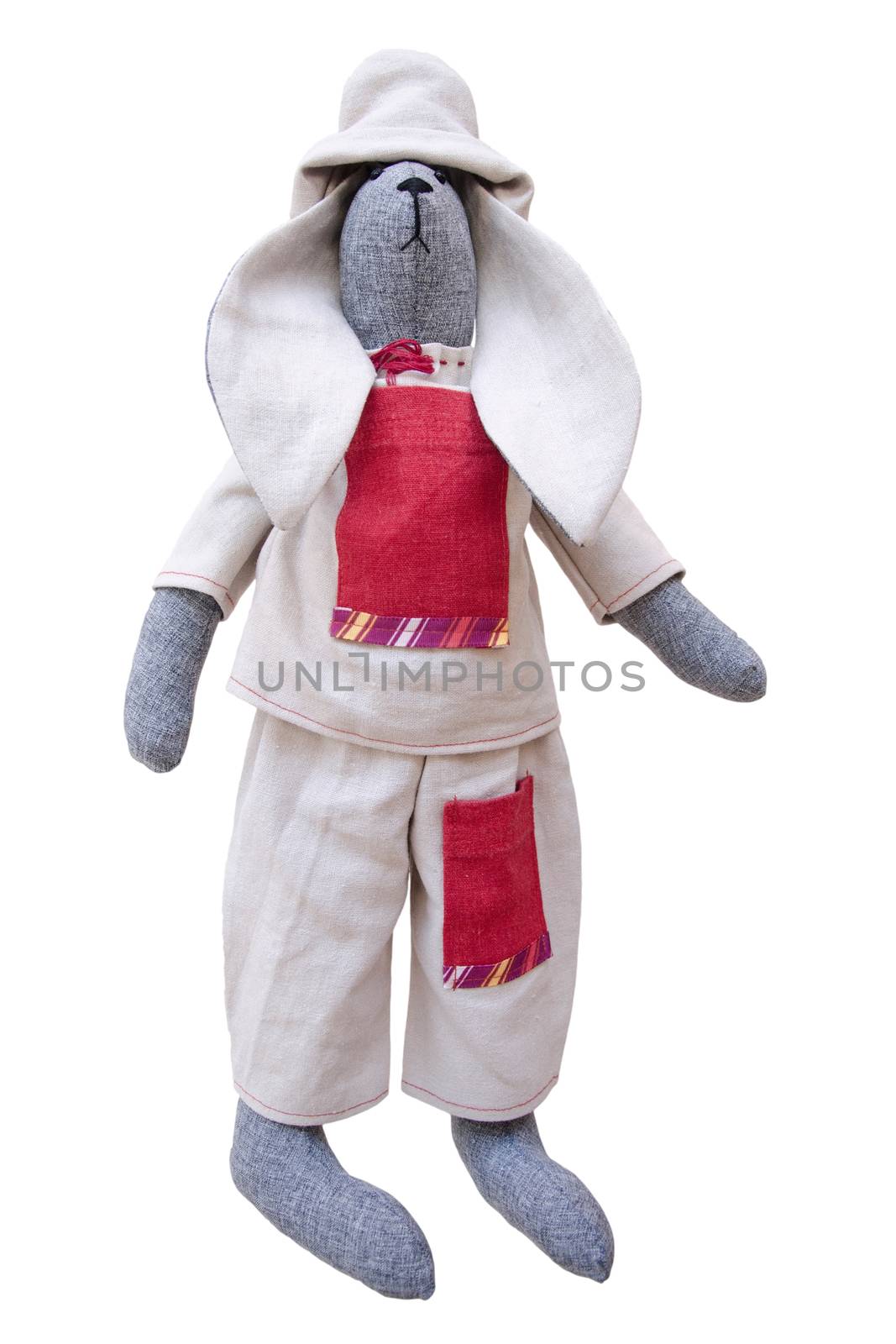 The isolated handmade doll bunny in homespun jacket, pants with pockets and a fishing hat