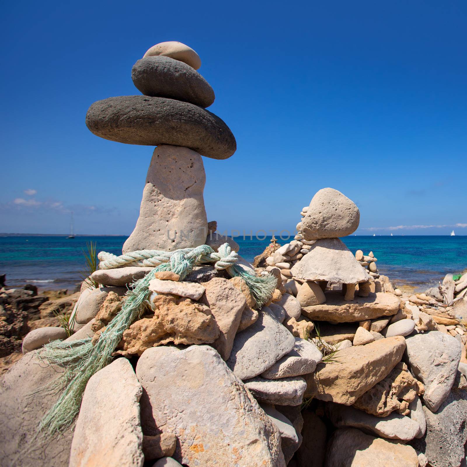 Stone figures on beach shore of Illetes beach in Formentera Mediterranean Balearic Islands