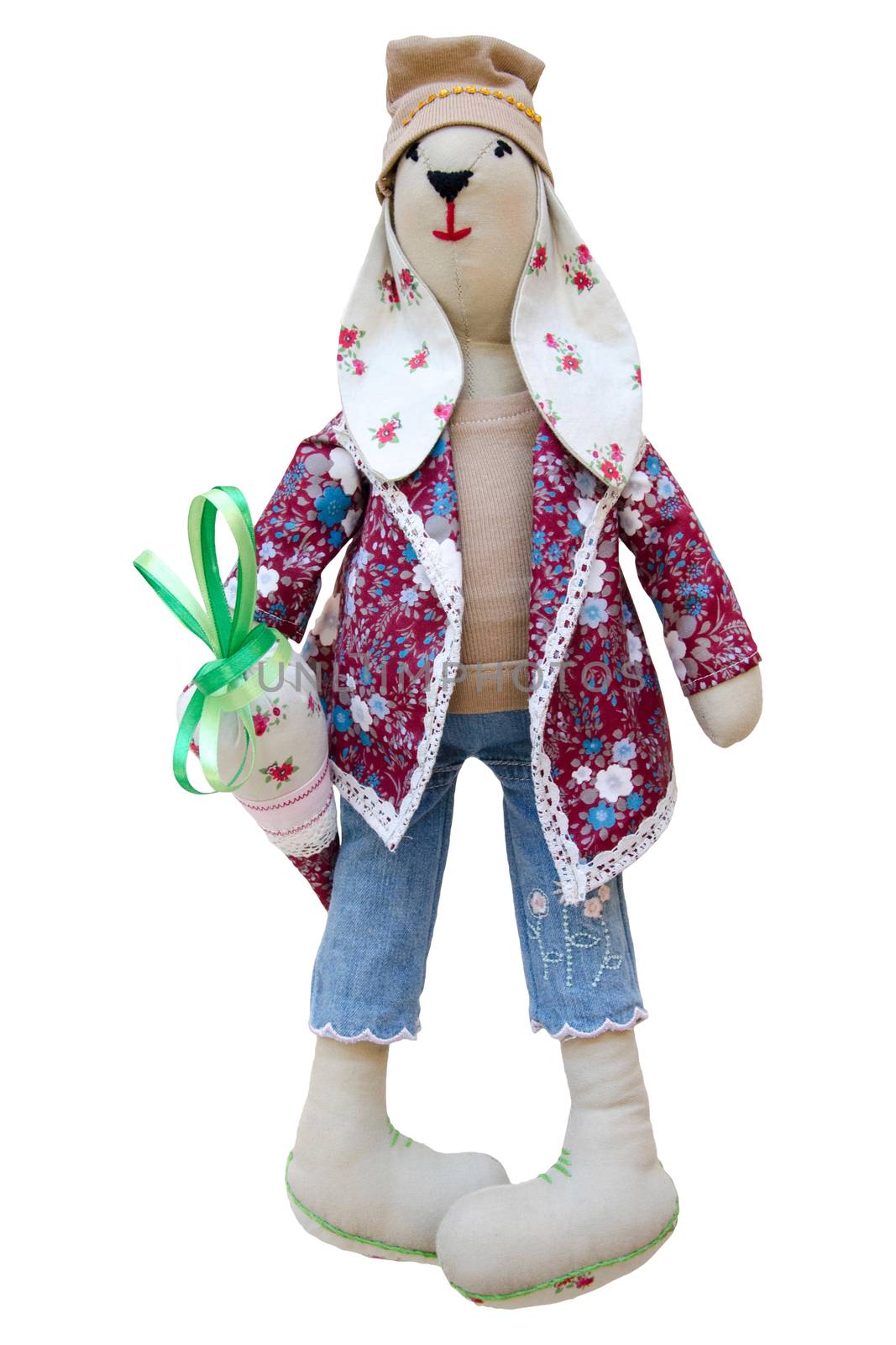 The Isolated handmade doll hare in fashionable clothes with carrots
