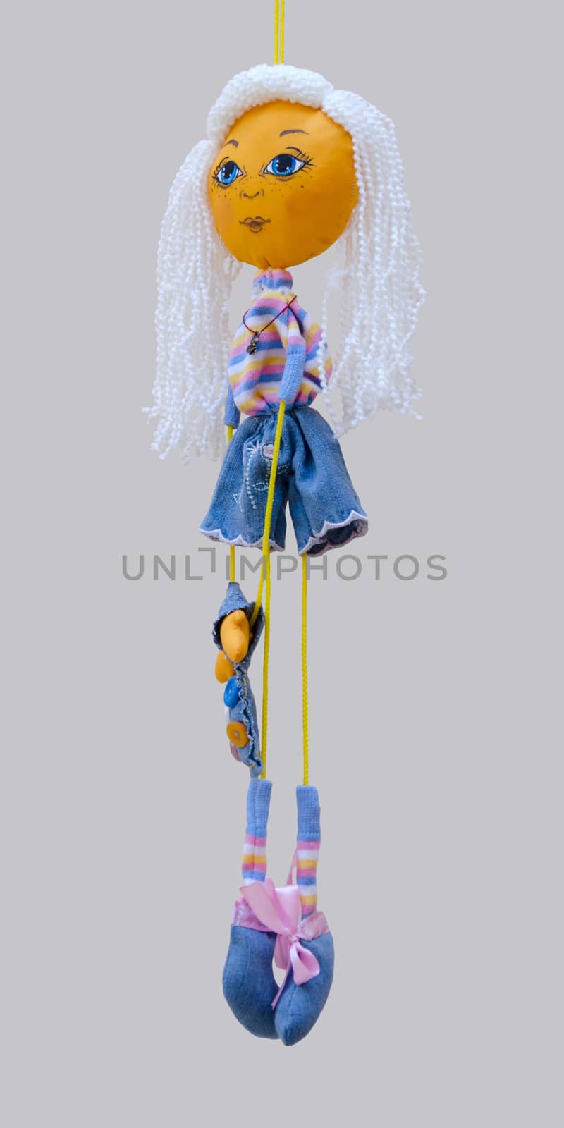 The handmade doll toy isolated thin blond cheerful girl in jeans dress with bag