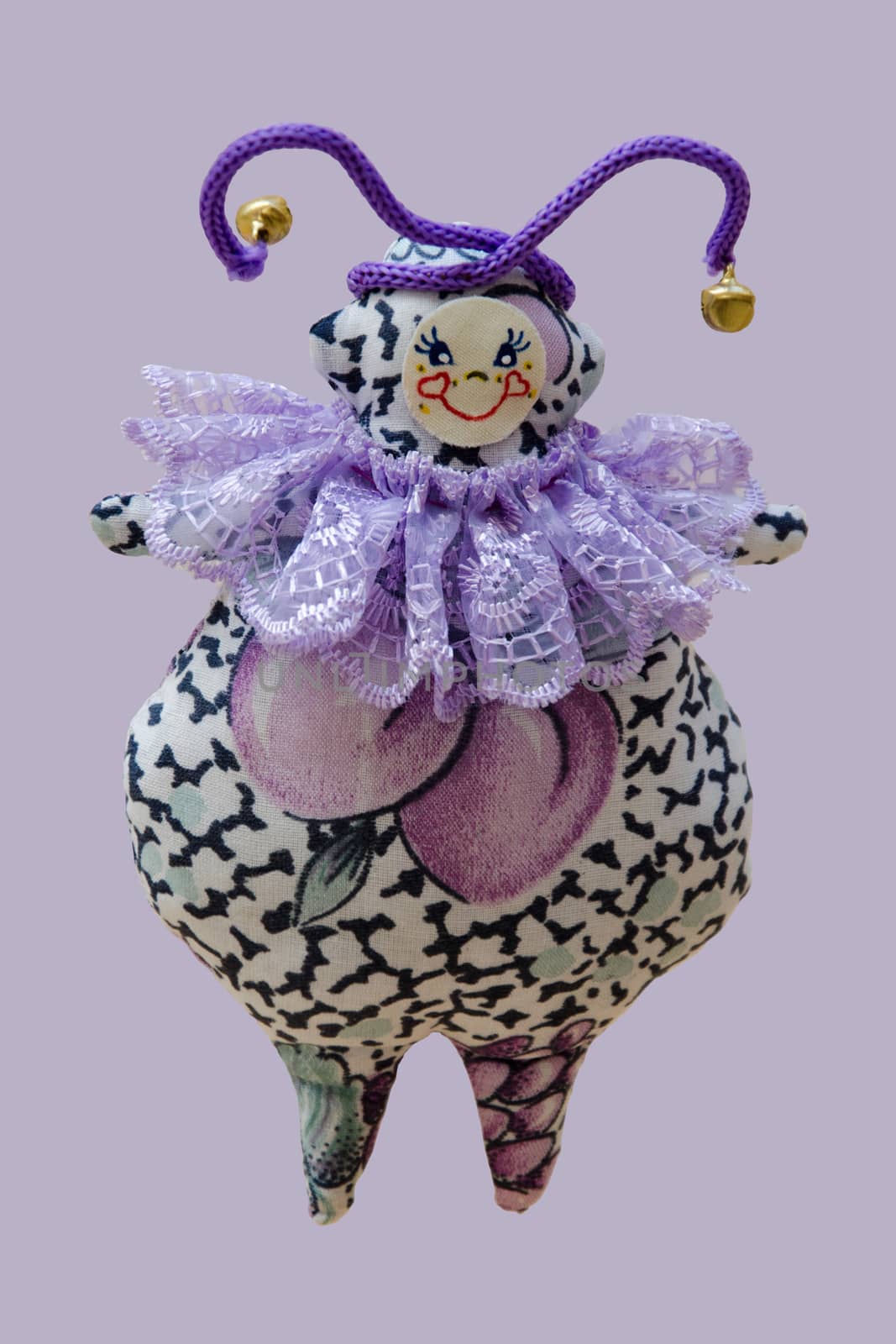 The Hand made soft toy doll isolated on purple background