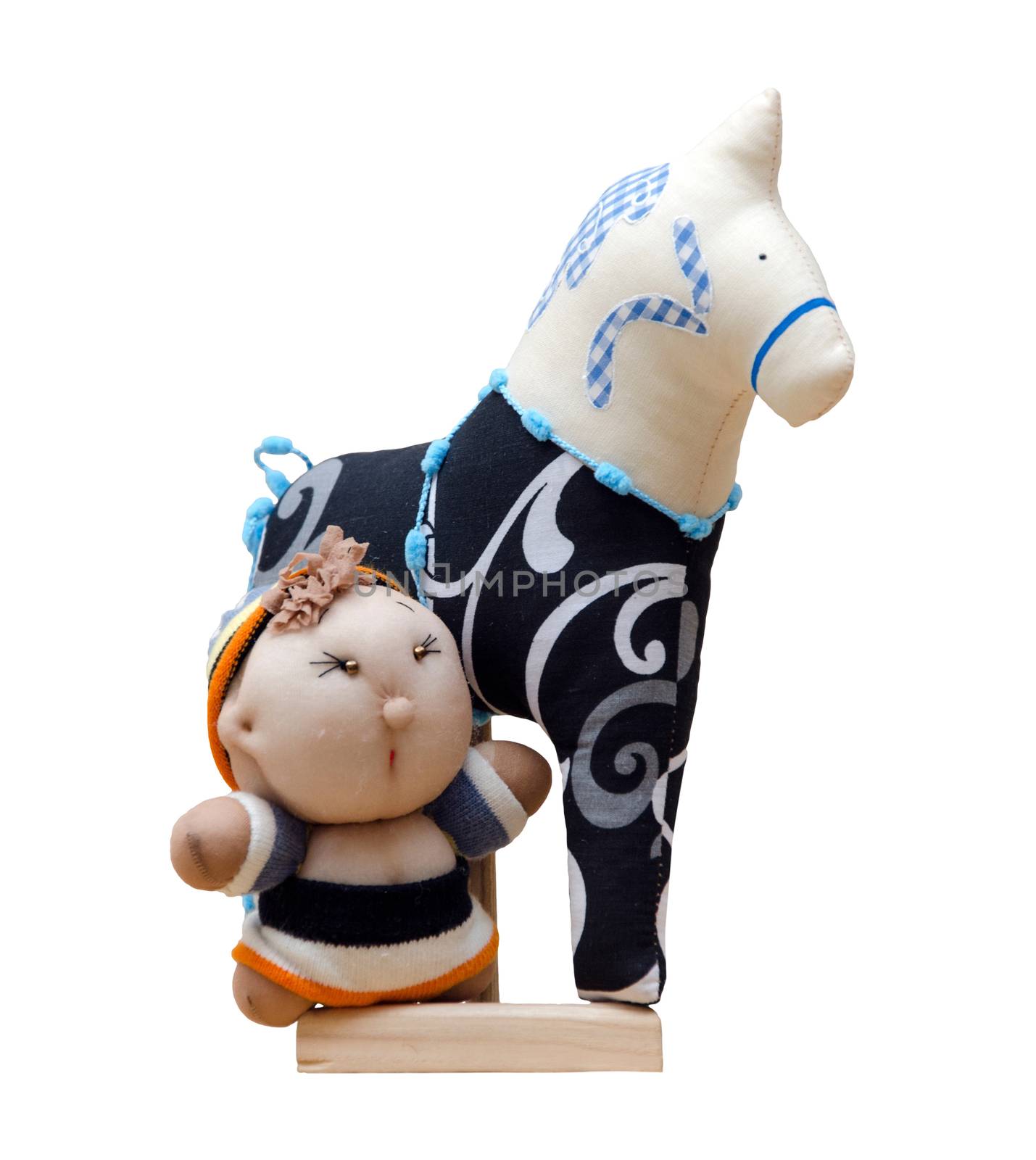 The Hand made soft toy horse isolated on black with blue on the stand & baby