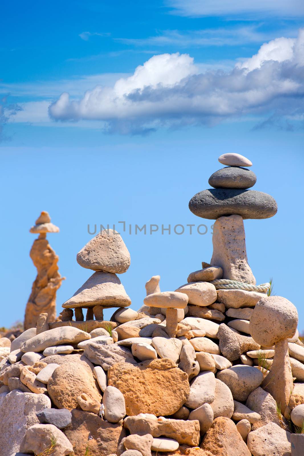 Stone figures on beach shore of Illetes beach in Formentera by lunamarina