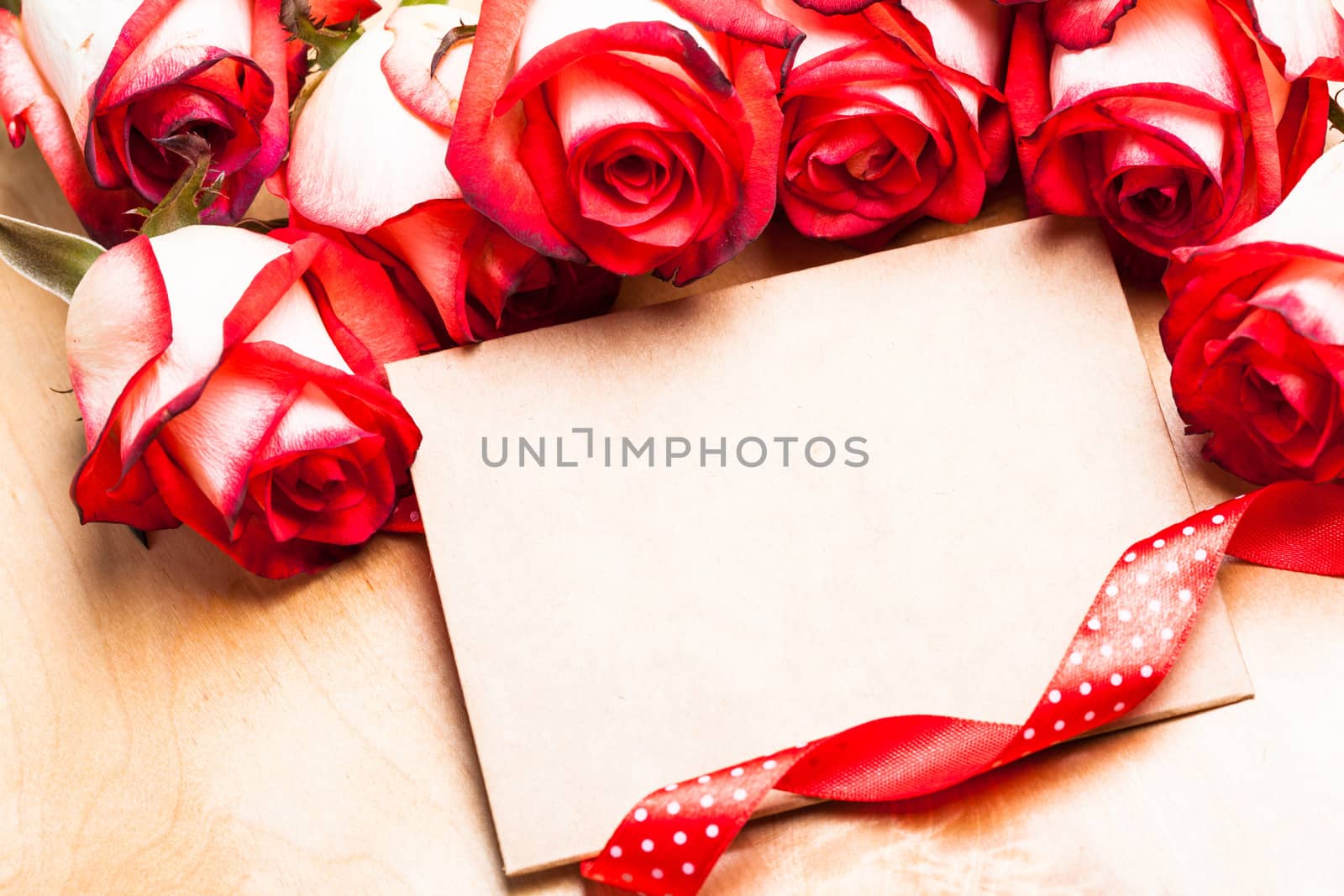 Craft card with red roses and ribbon for greetings