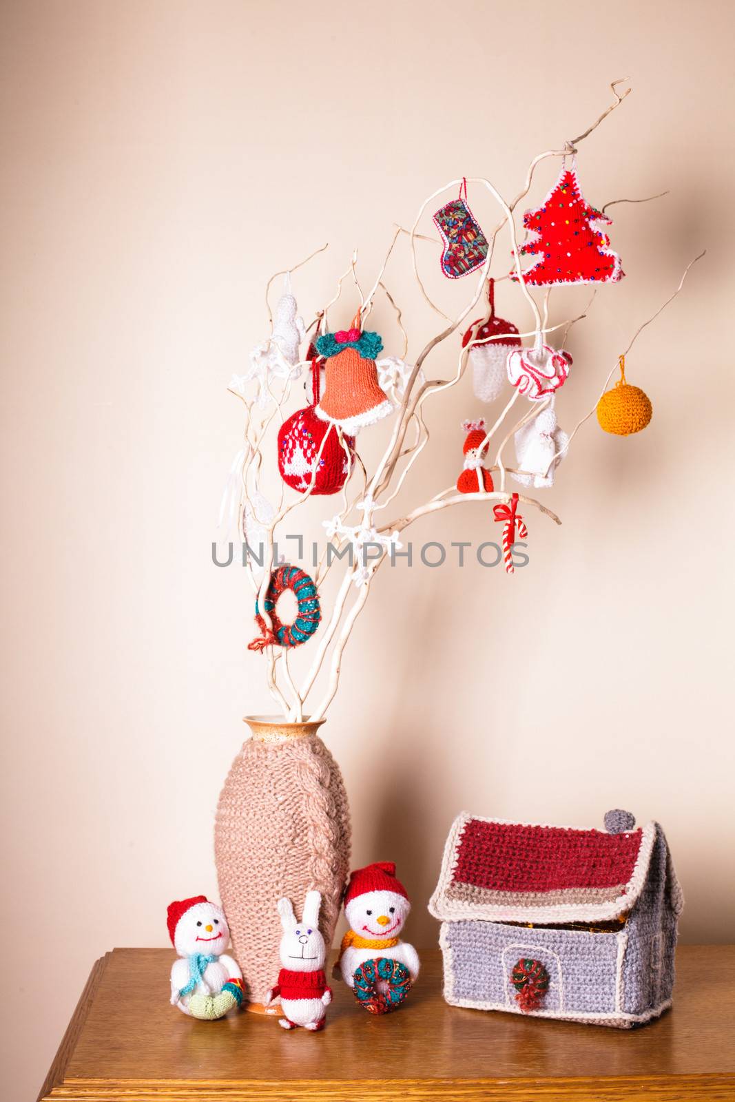 Christmas handmade decor on the branches over wall