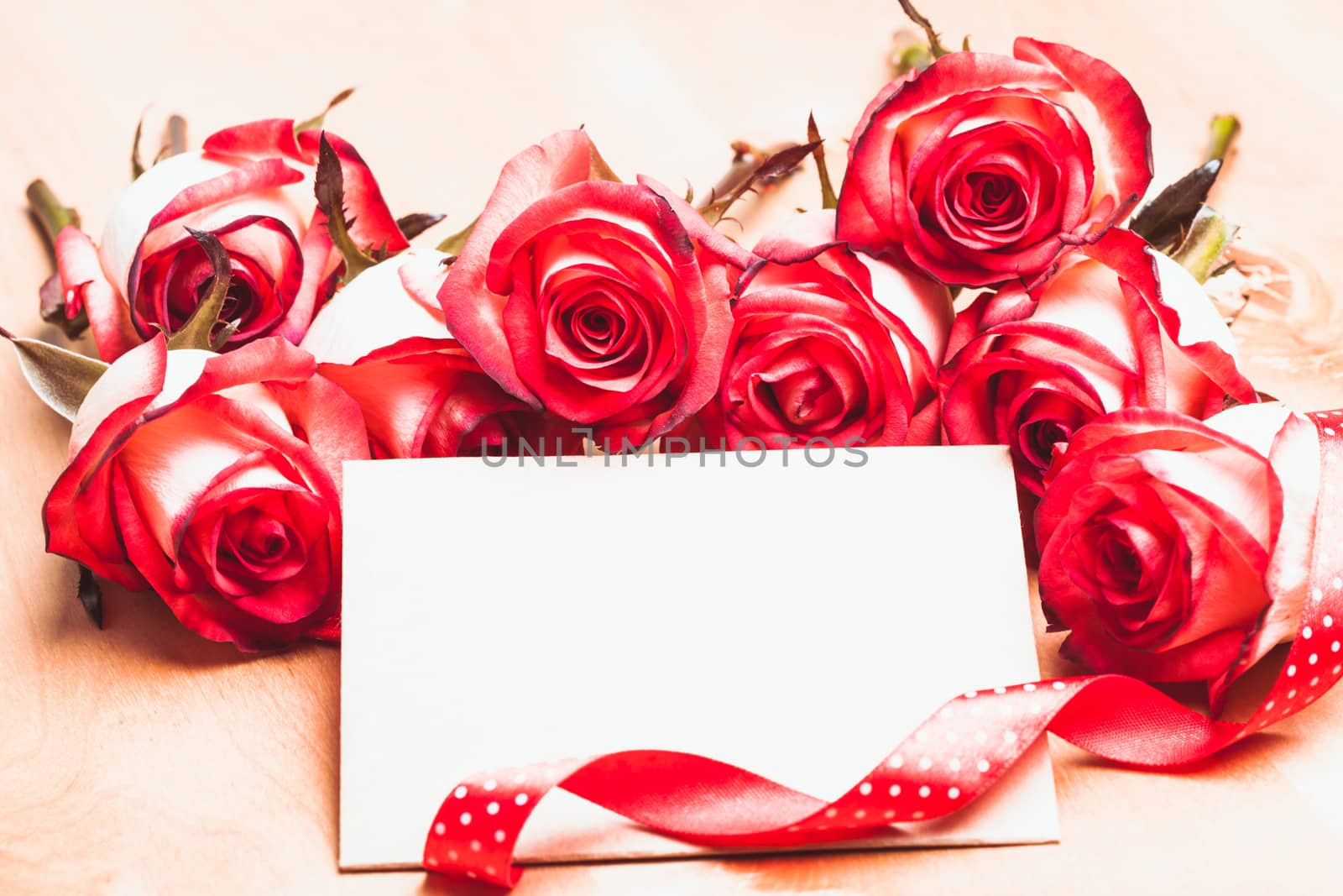 Craft card with red roses and ribbon for greetings