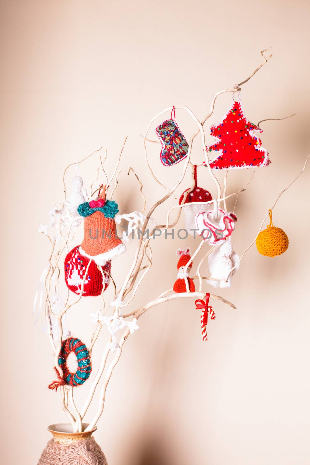 Christmas handmade decor on the branches over wall