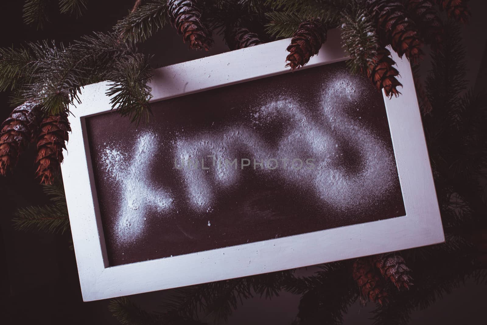 Chalkboard on the pine with "Xmas" word
