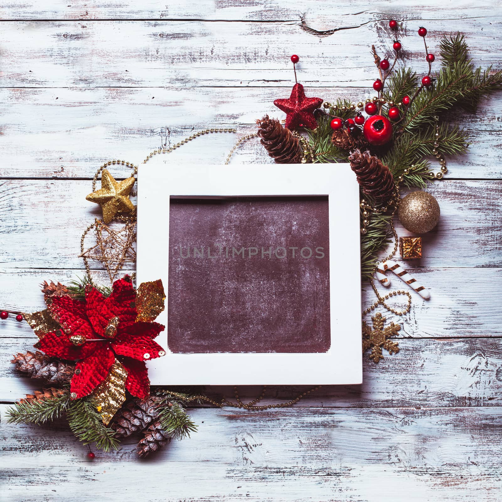 Christmas vintage chalkboard with decorations on shabby white wooden background